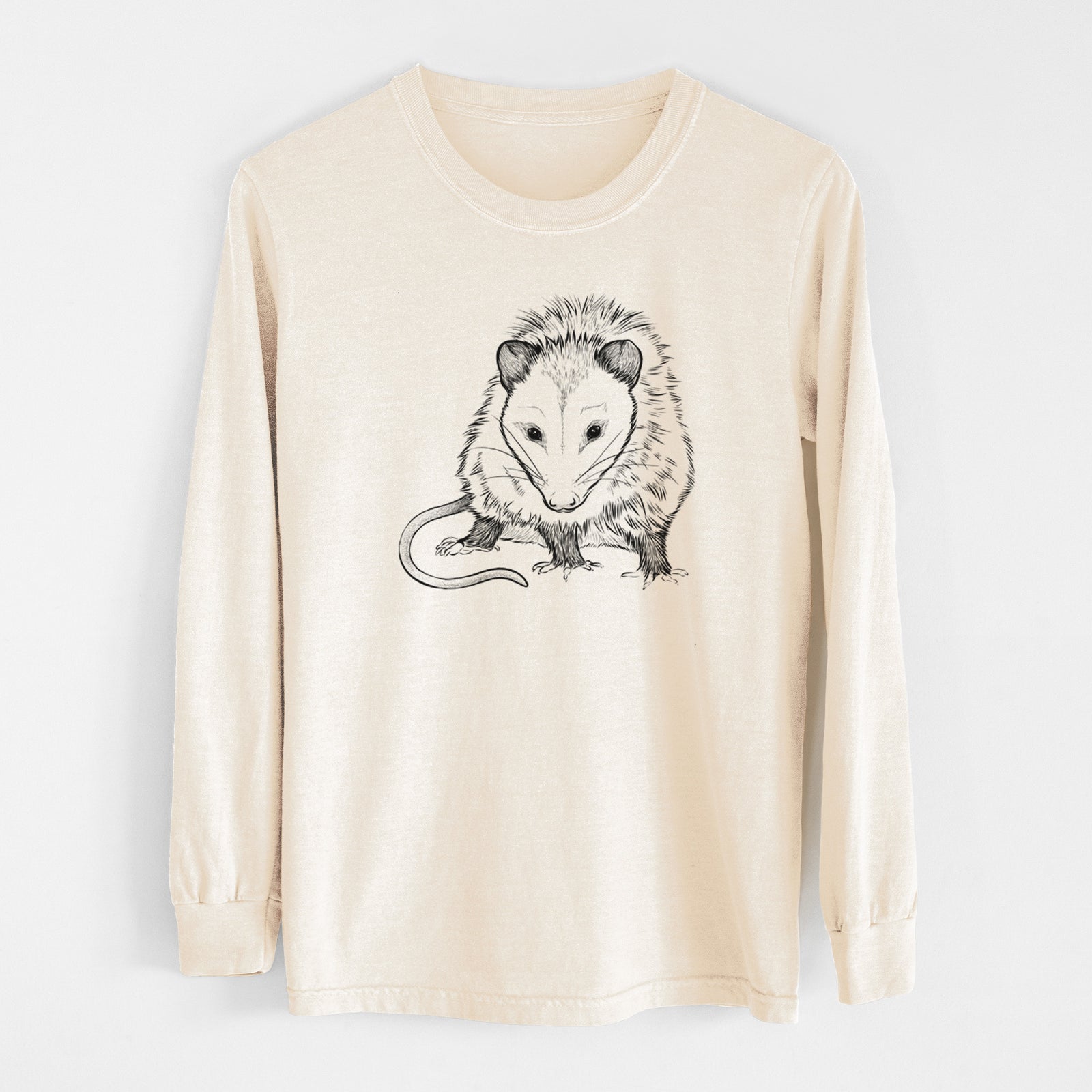 Yam burnt orange Comfort Colors long sleeve shirt laid flat with the cuffs rolled, printed with a detailed black ink illustration of a Virginia opossum standing with its long tail curled.