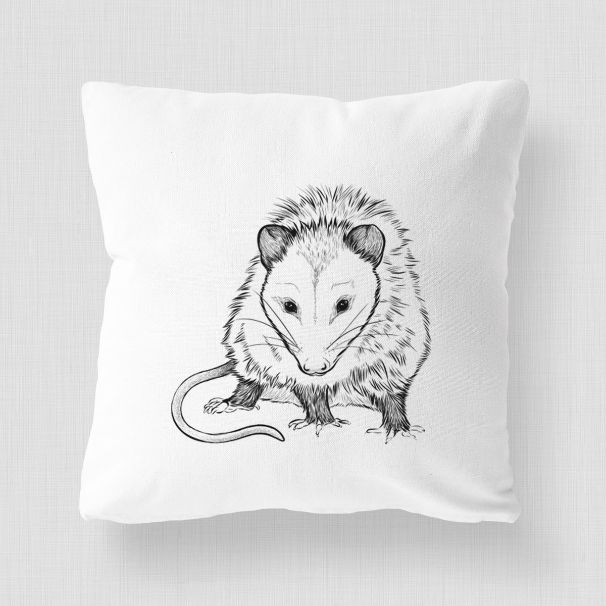 White pillow cover printed with a detailed black ink illustration of a Virginia opossum standing with its long tail curled.