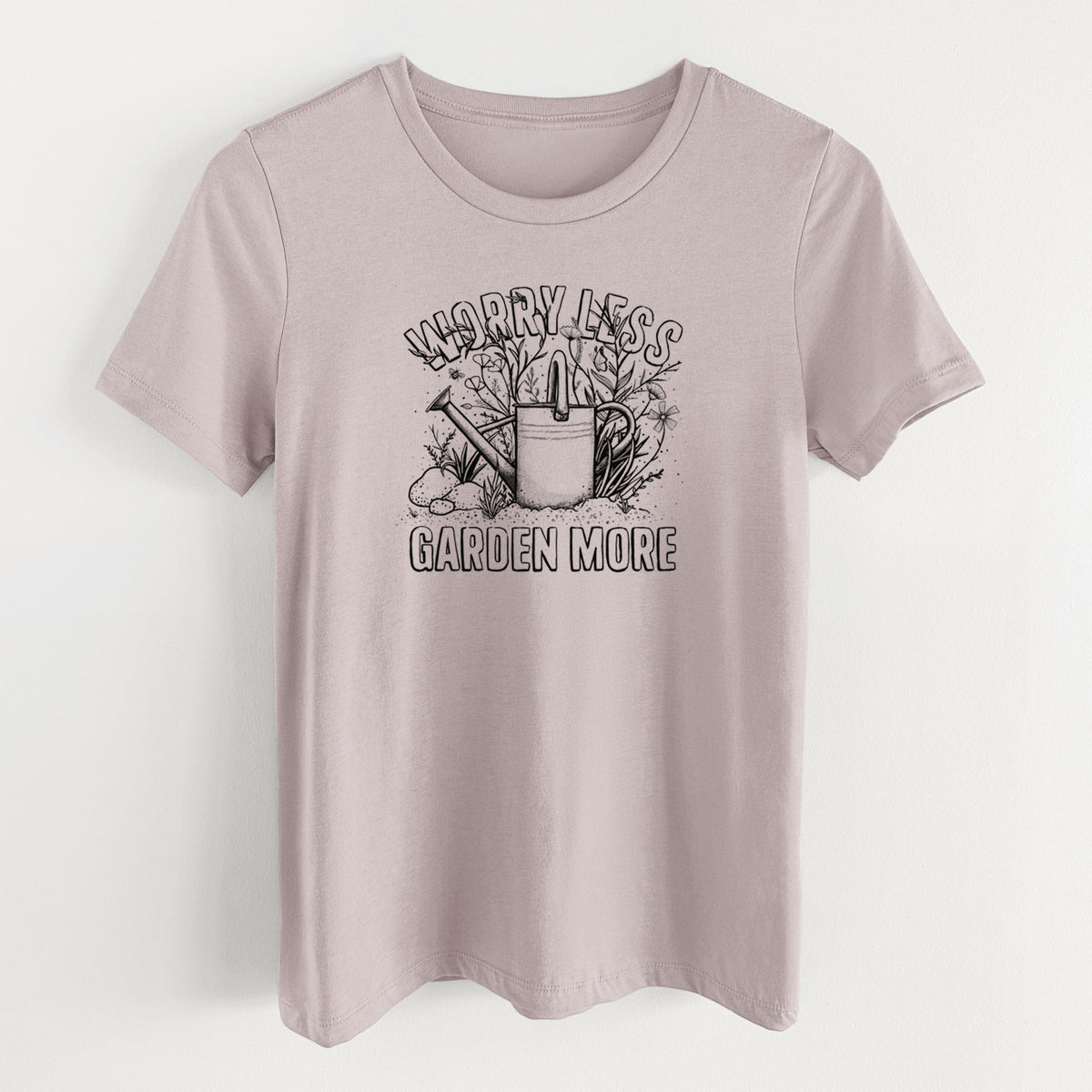 Pink gravel women's relaxed fit cotton t-shirt laid flat, printed with a black ink watering can surrounded by flowers and garden tools, with the words Worry Less, Garden More.