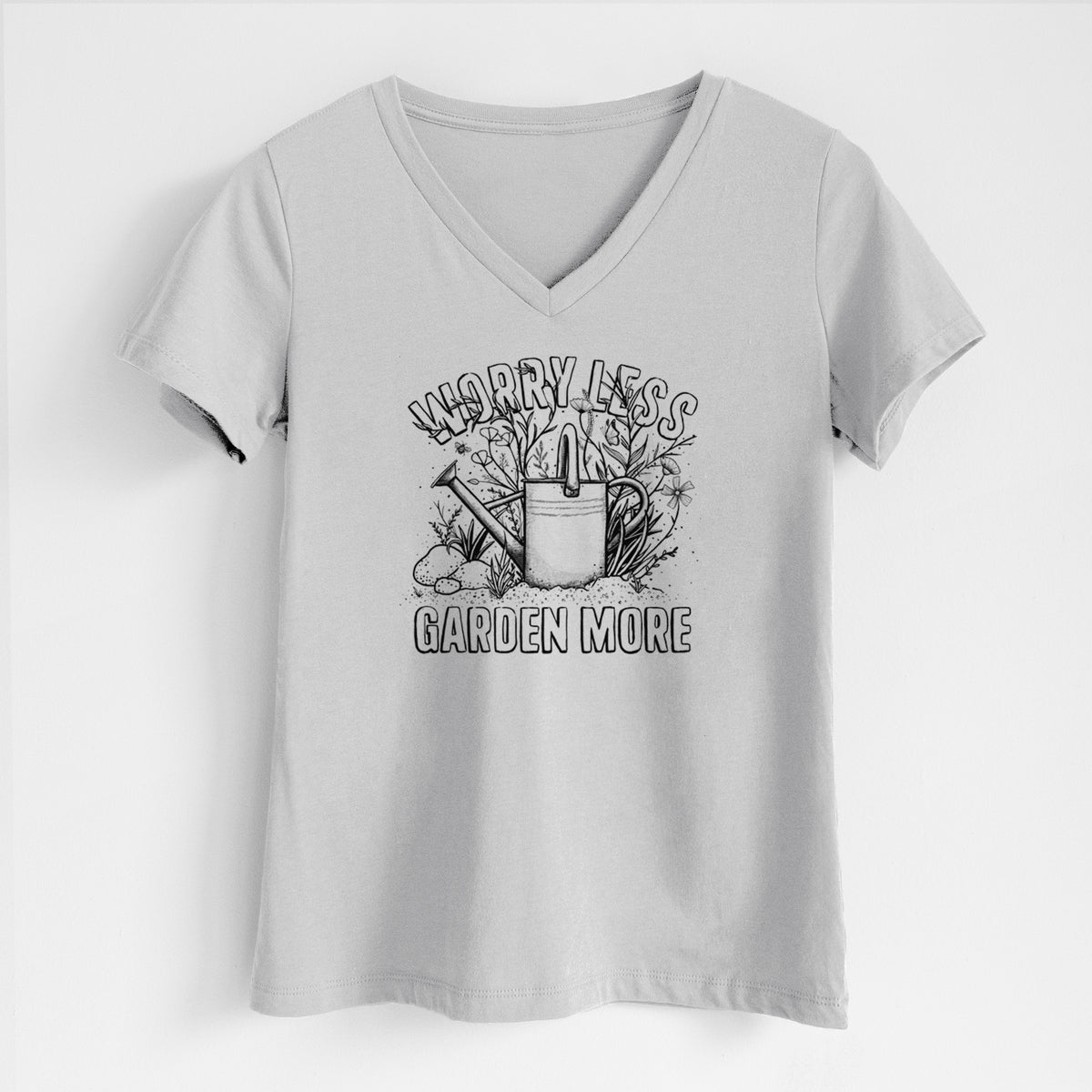 Lunar grey women's relaxed fit cotton V-neck t-shirt laid flat, printed with a black ink watering can surrounded by flowers and garden tools, with the words Worry Less, Garden More.
