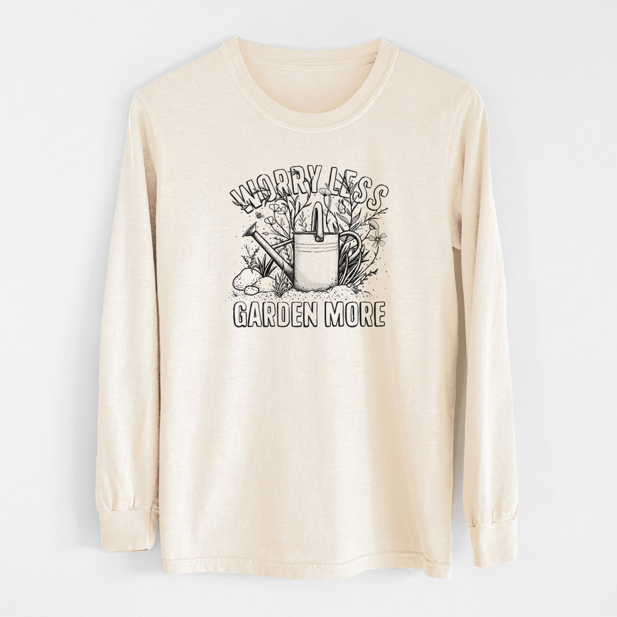 Ivory Comfort Colors long sleeve shirt laid flat, printed with a black ink watering can surrounded by flowers and garden tools, with the words Worry Less, Garden More.