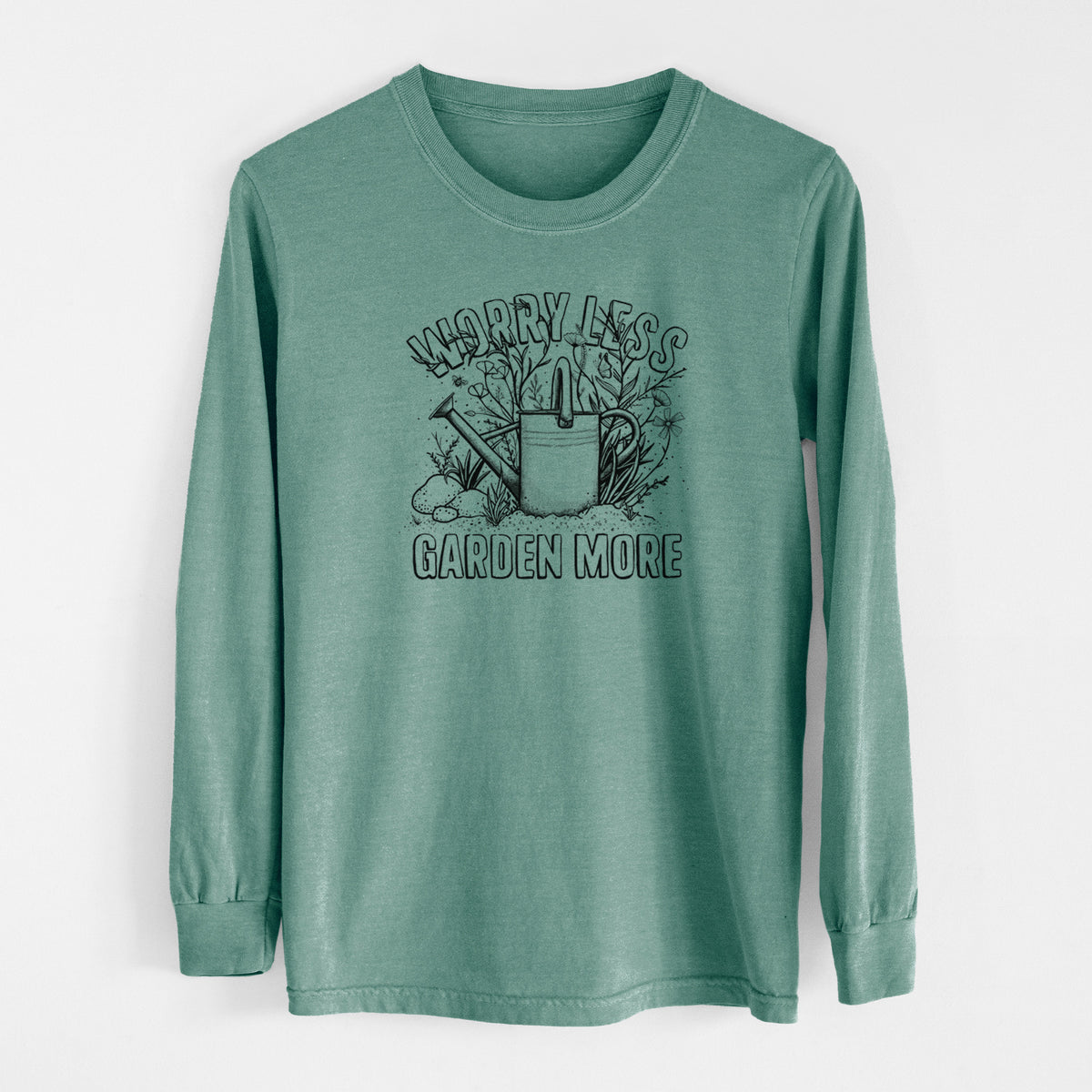 Pine green Comfort Colors long sleeve shirt laid flat, printed with a black ink watering can surrounded by flowers and garden tools, with the words Worry Less, Garden More.
