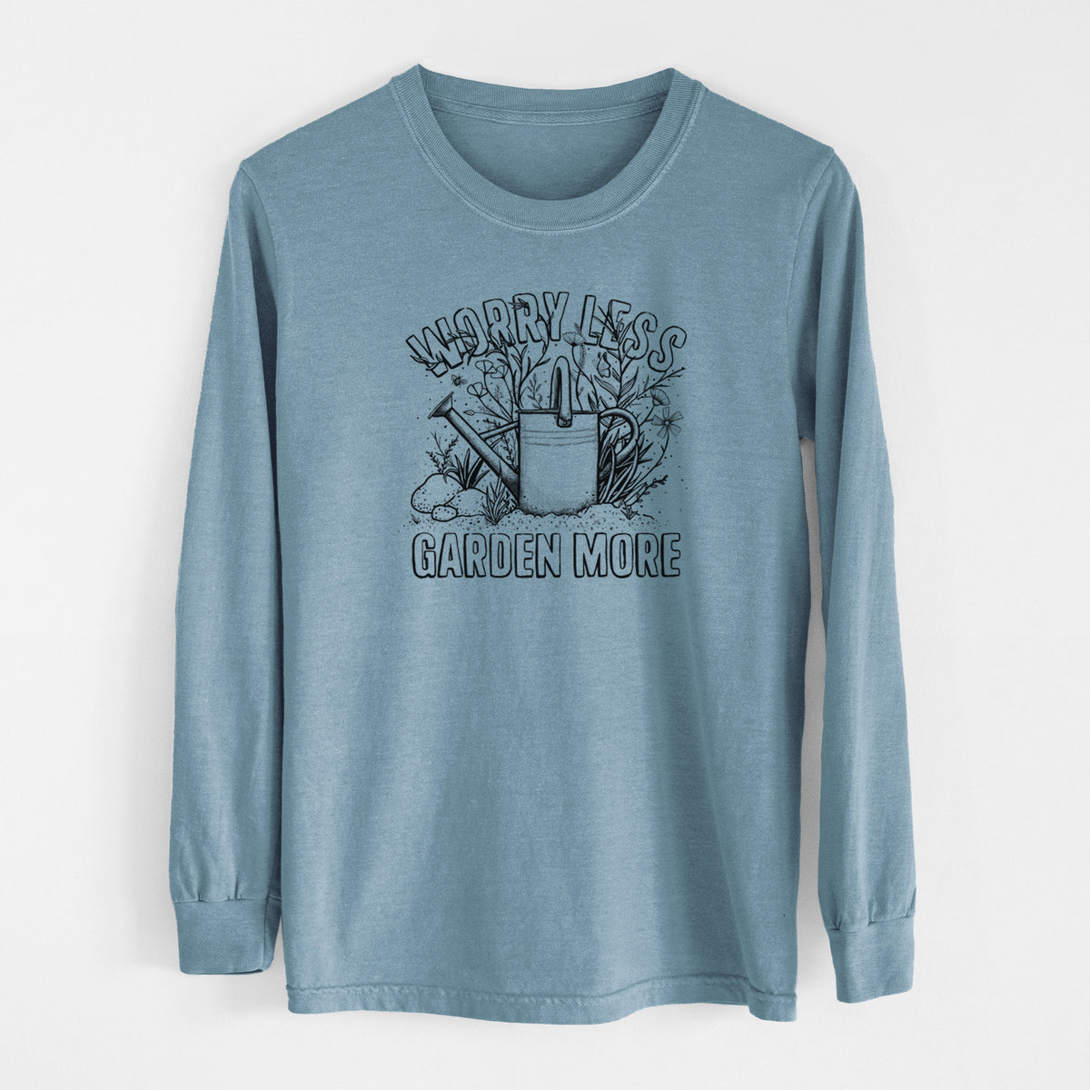 Steel blue Comfort Colors long sleeve shirt laid flat, printed with a black ink watering can surrounded by flowers and garden tools, with the words Worry Less, Garden More.
