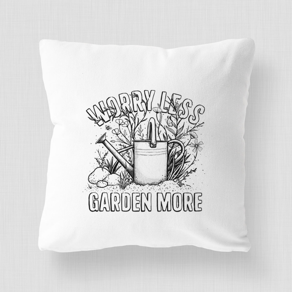White pillow cover printed with a black ink watering can surrounded by flowers and garden tools, with the words Worry Less, Garden More.