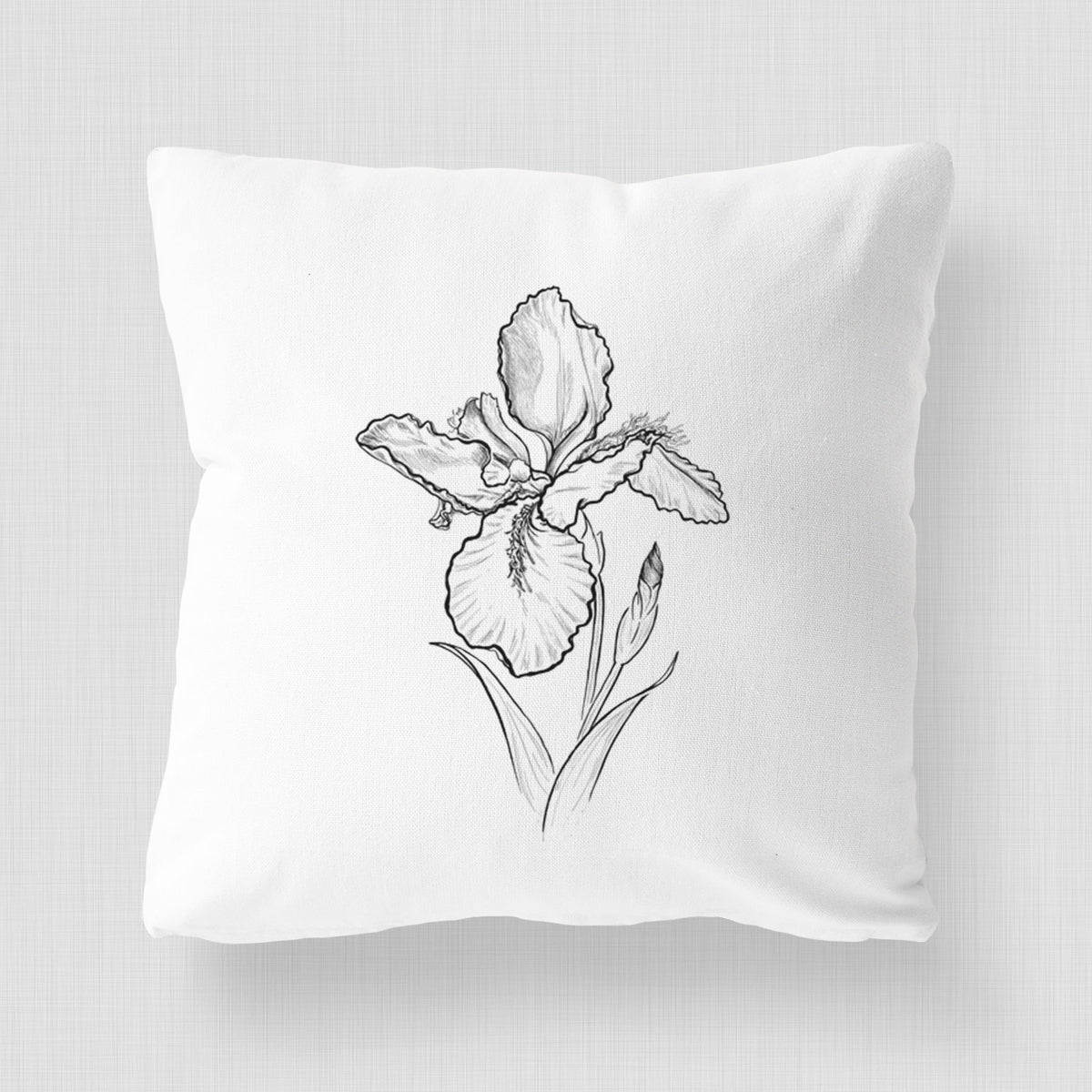 White pillow cover printed with a black ink line drawing of a wall iris flower on its stem.