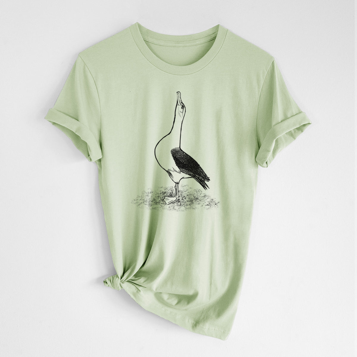 Spring green lightweight cotton t-shirt laid flat with the sleeves rolled, printed with a black ink illustration of a wandering albatross with its head raised.