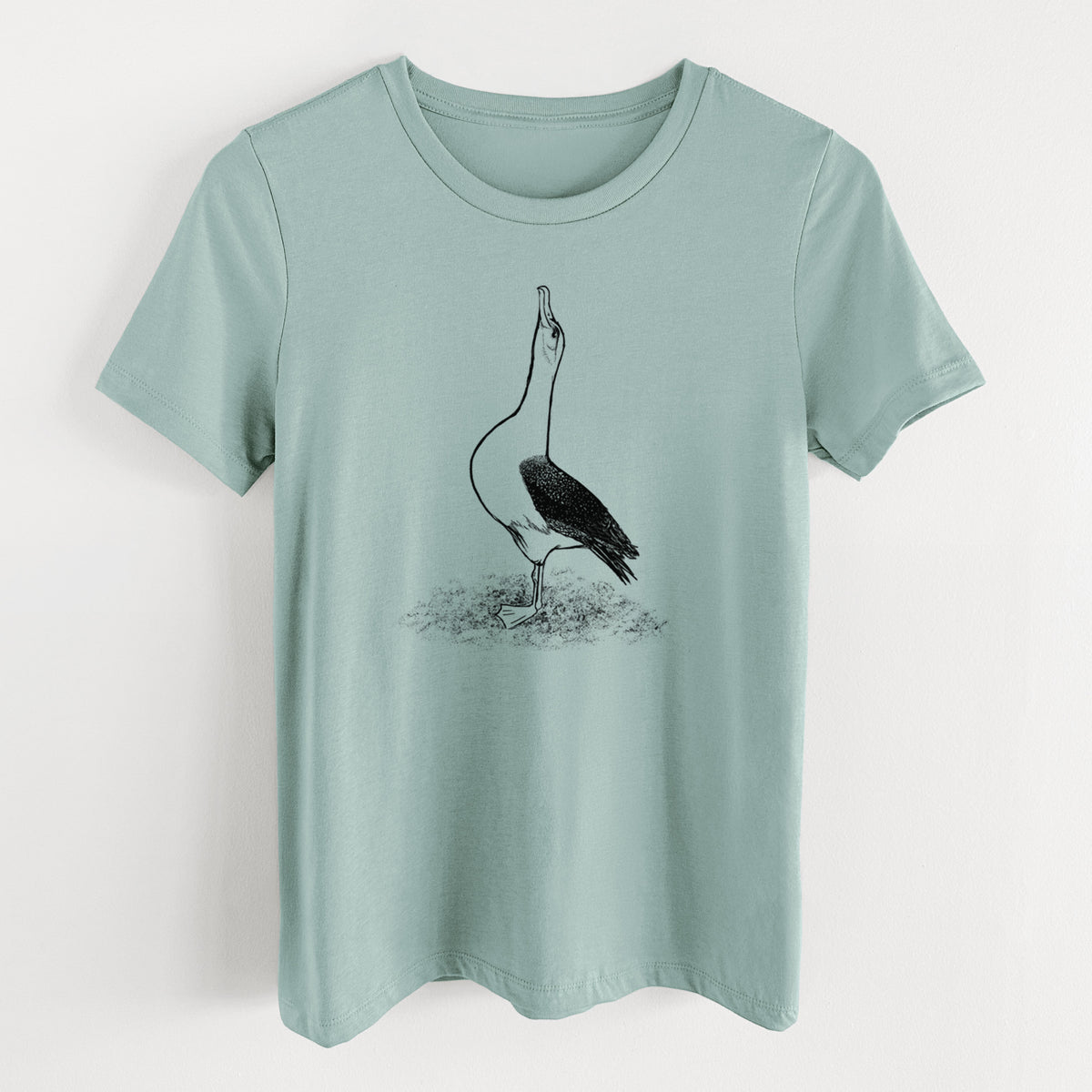 Dusty blue women's relaxed fit cotton t-shirt laid flat, printed with a black ink illustration of a wandering albatross with its head raised.