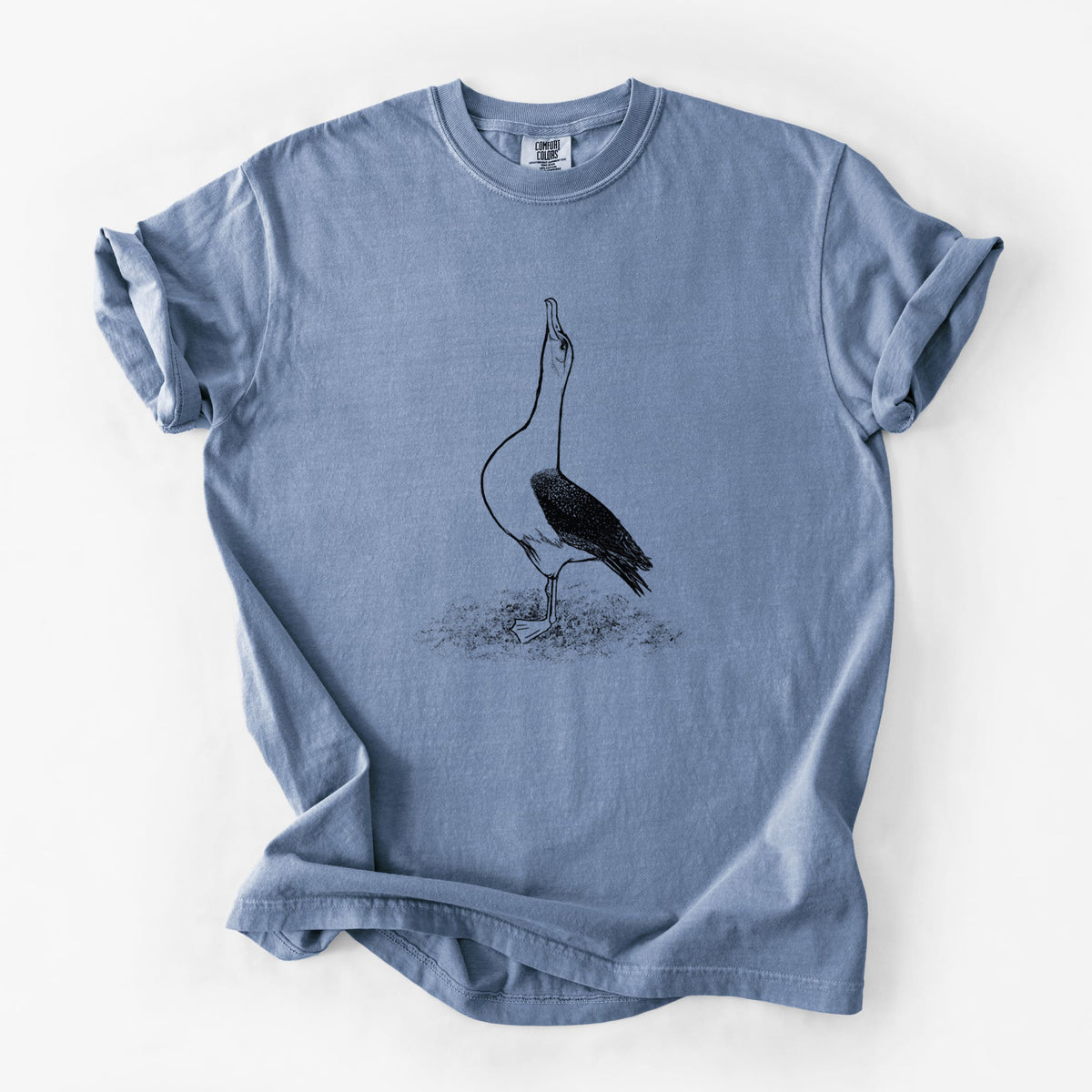 Blue jean Comfort Colors t-shirt laid flat, printed with a black ink illustration of a wandering albatross with its head raised.