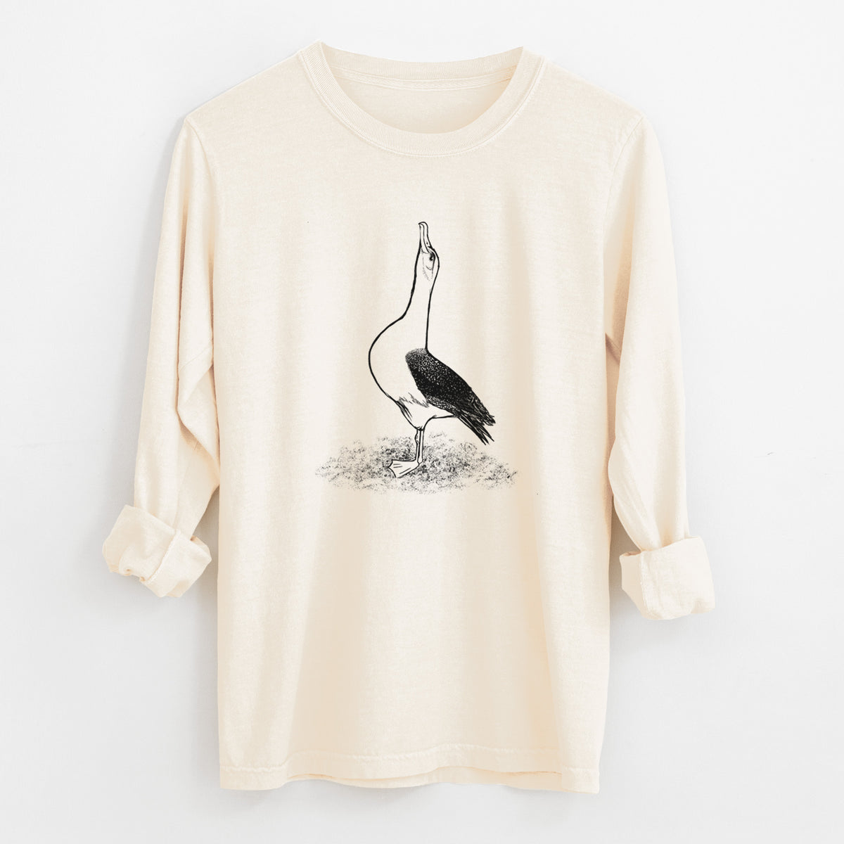Ivory Comfort Colors long sleeve shirt laid flat with the cuffs rolled, printed with a black ink illustration of a wandering albatross with its head raised.