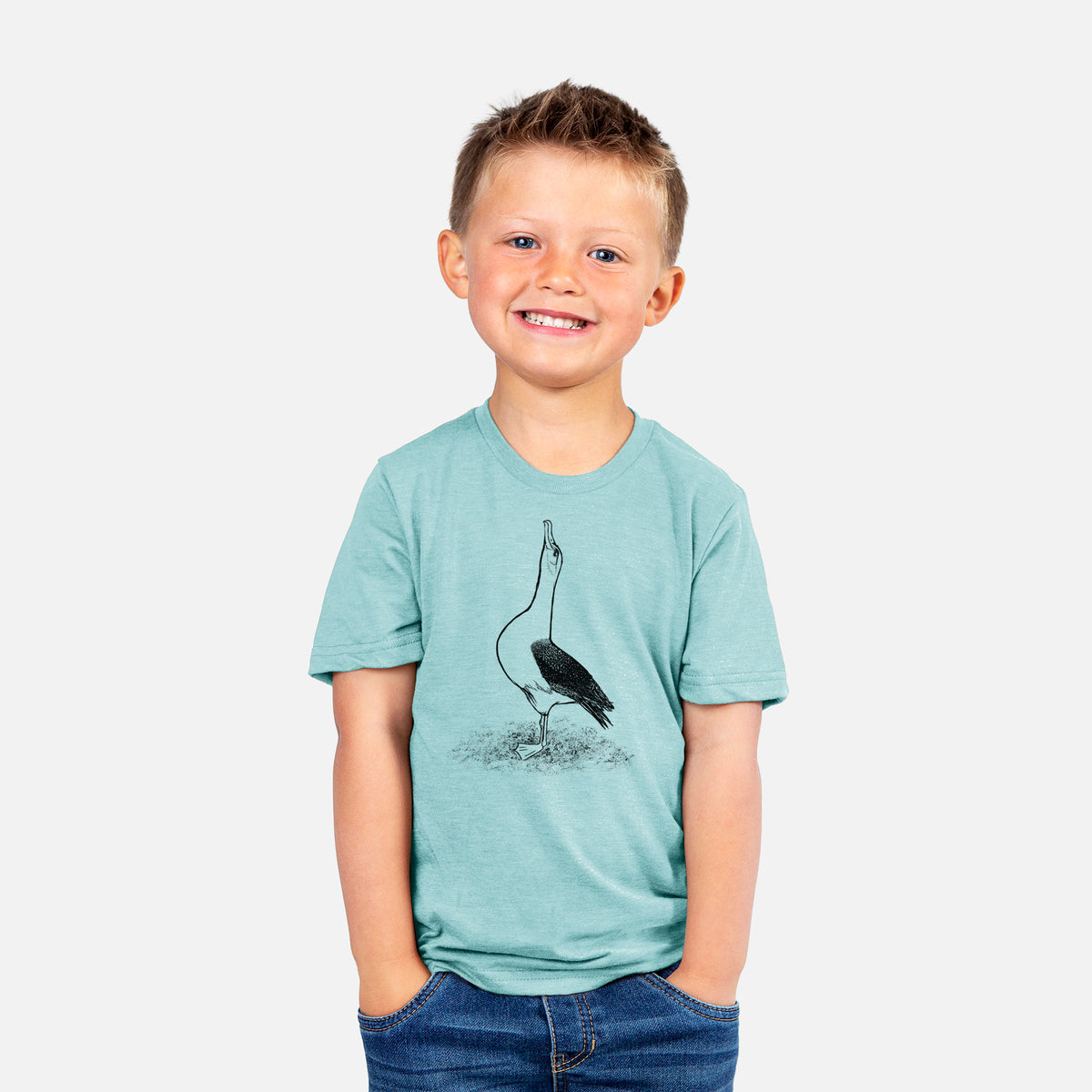 Smiling boy wearing a youth t-shirt printed with a black ink illustration of a wandering albatross with its head raised.