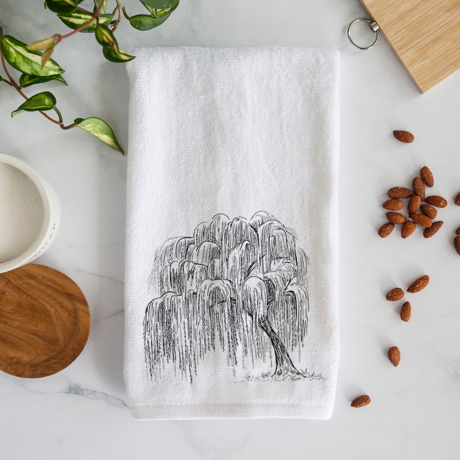 White hand towel printed with a black ink illustration of a weeping willow tree.