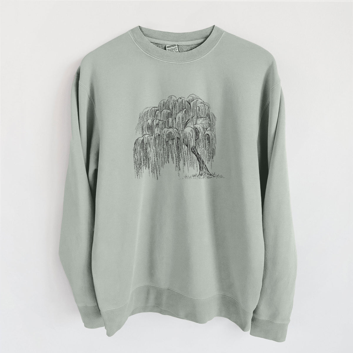 Sage green pigment dyed crewneck sweatshirt laid flat, printed with a black ink illustration of a weeping willow tree.
