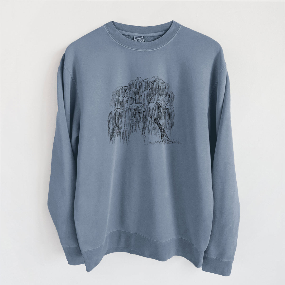 Slate blue pigment dyed crewneck sweatshirt laid flat, printed with a black ink illustration of a weeping willow tree.