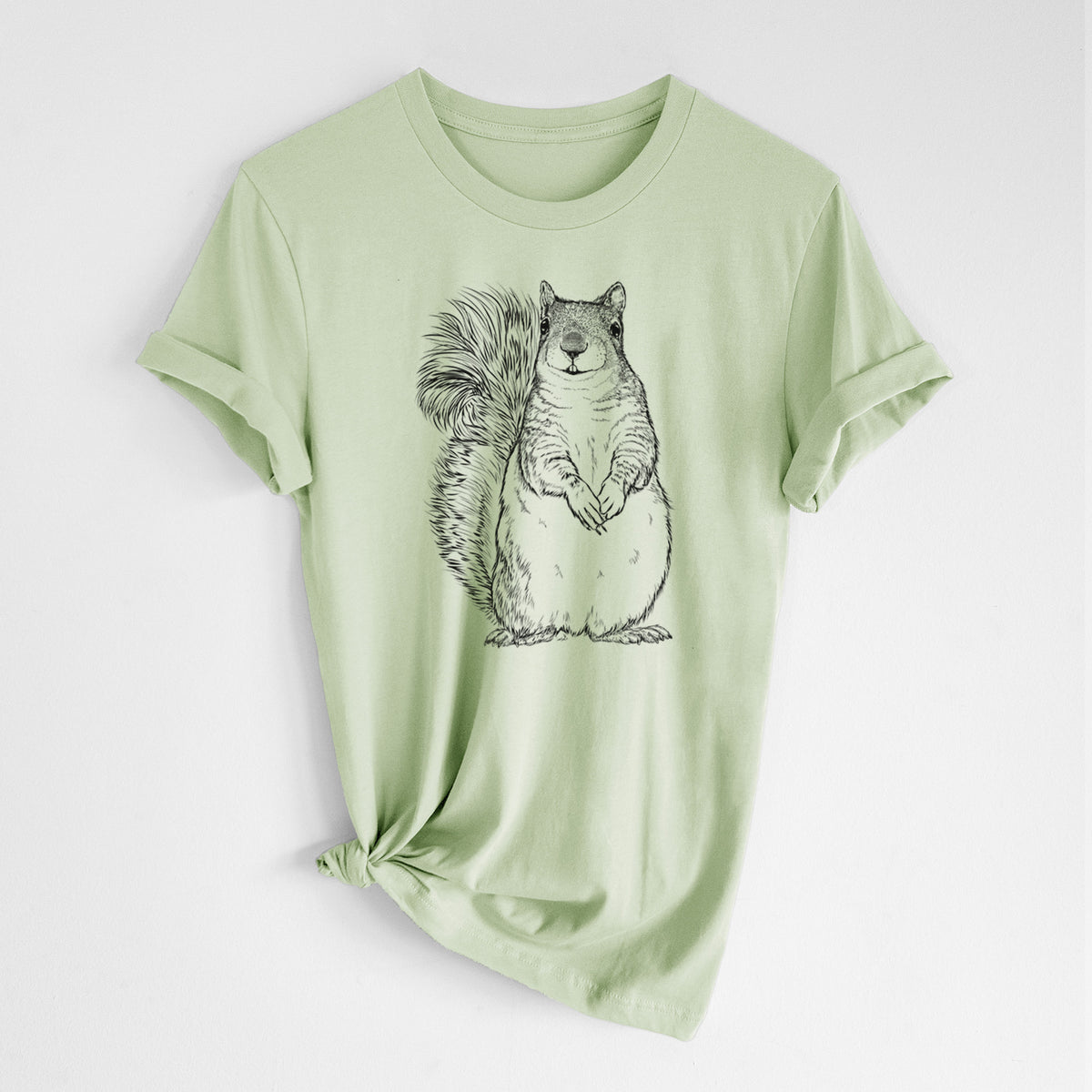 Spring green lightweight cotton t-shirt laid flat with the sleeves rolled, printed with a detailed black ink illustration of a western grey squirrel sitting upright with a bushy tail.