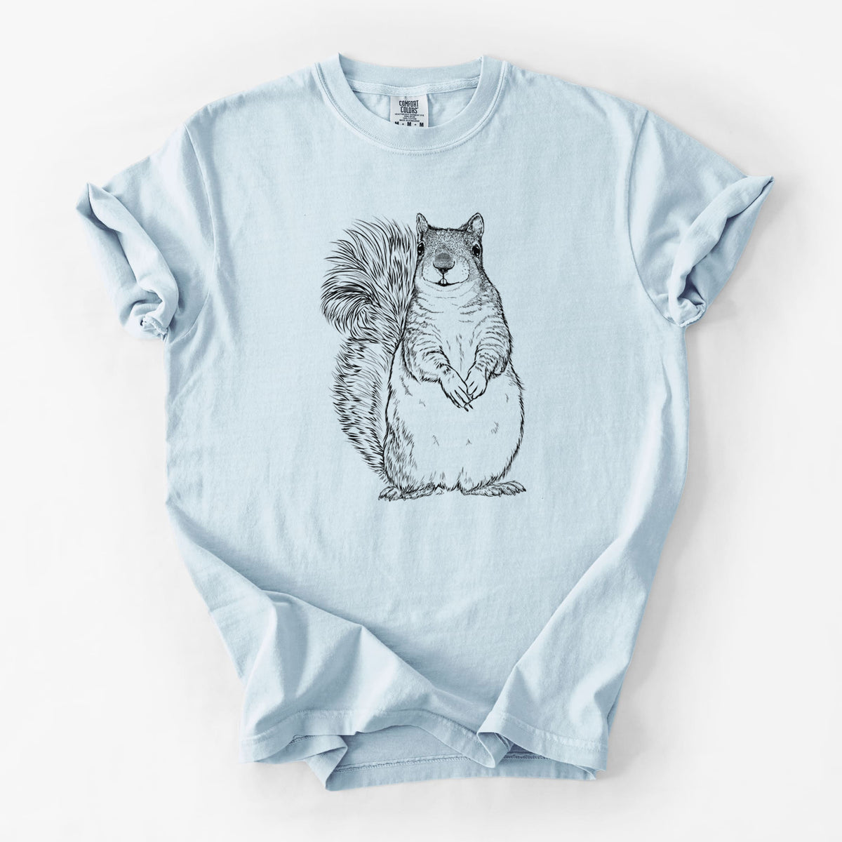Chambray blue Comfort Colors t-shirt laid flat, printed with a detailed black ink illustration of a western grey squirrel sitting upright with a bushy tail.
