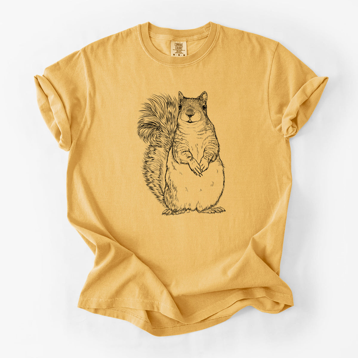 Golden wheat yellow Comfort Colors t-shirt laid flat, printed with a detailed black ink illustration of a western grey squirrel sitting upright with a bushy tail.