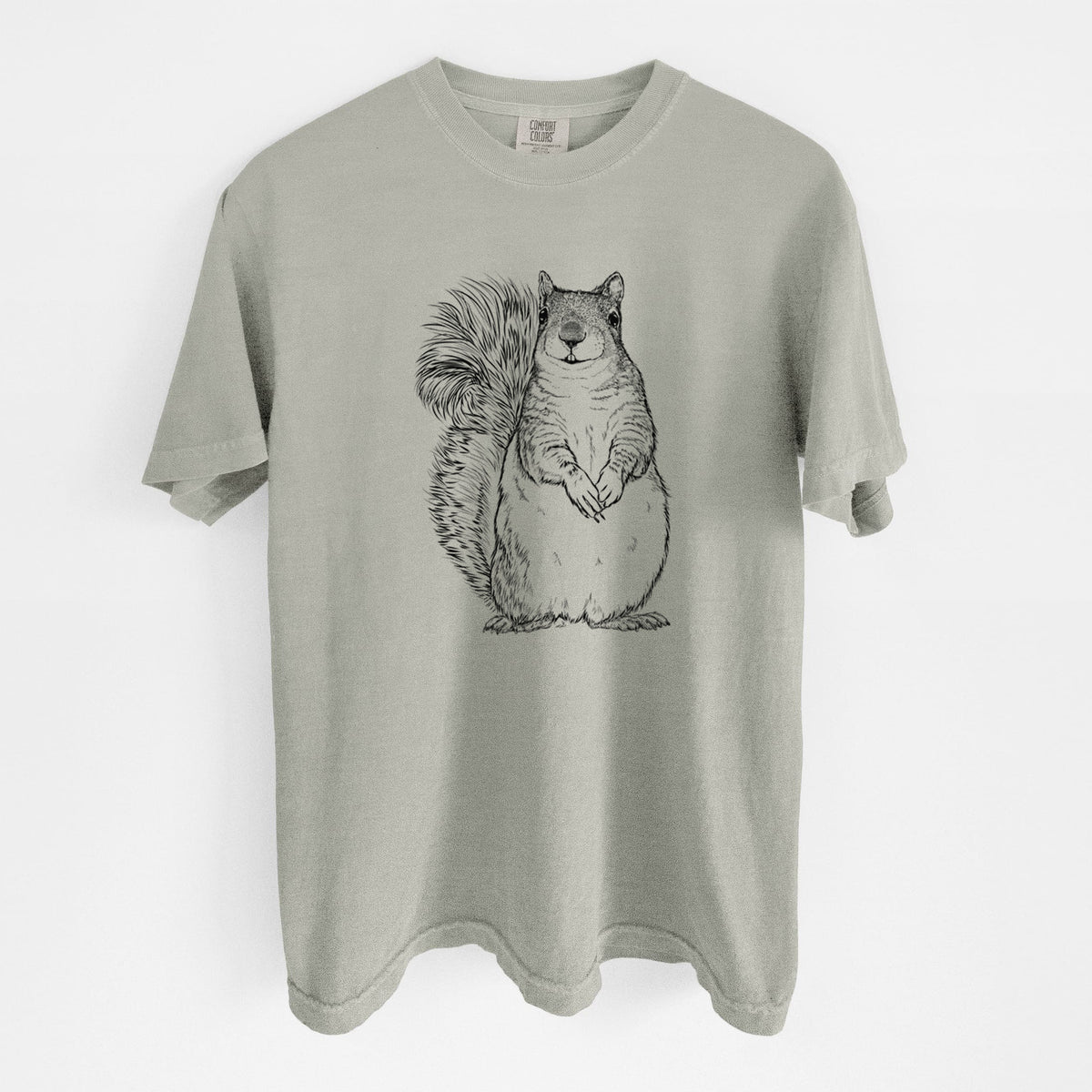 Sandstone beige Comfort Colors t-shirt laid flat, printed with a detailed black ink illustration of a western grey squirrel sitting upright with a bushy tail.