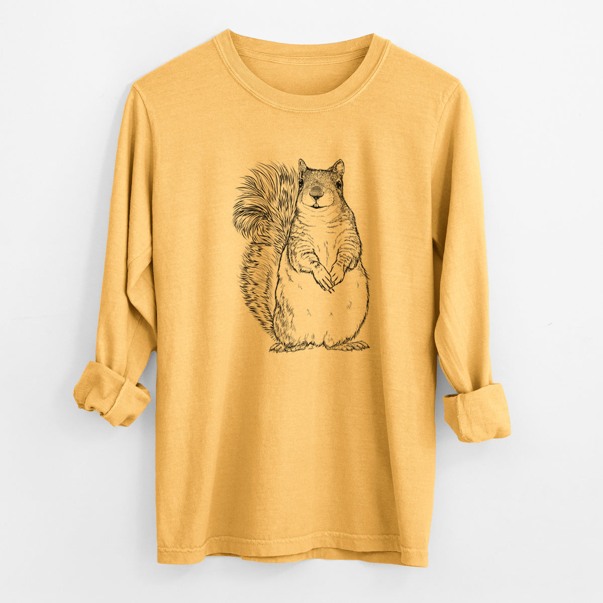 Golden wheat yellow Comfort Colors long sleeve shirt laid flat with the cuffs rolled, printed with a detailed black ink illustration of a western grey squirrel sitting upright with a bushy tail.