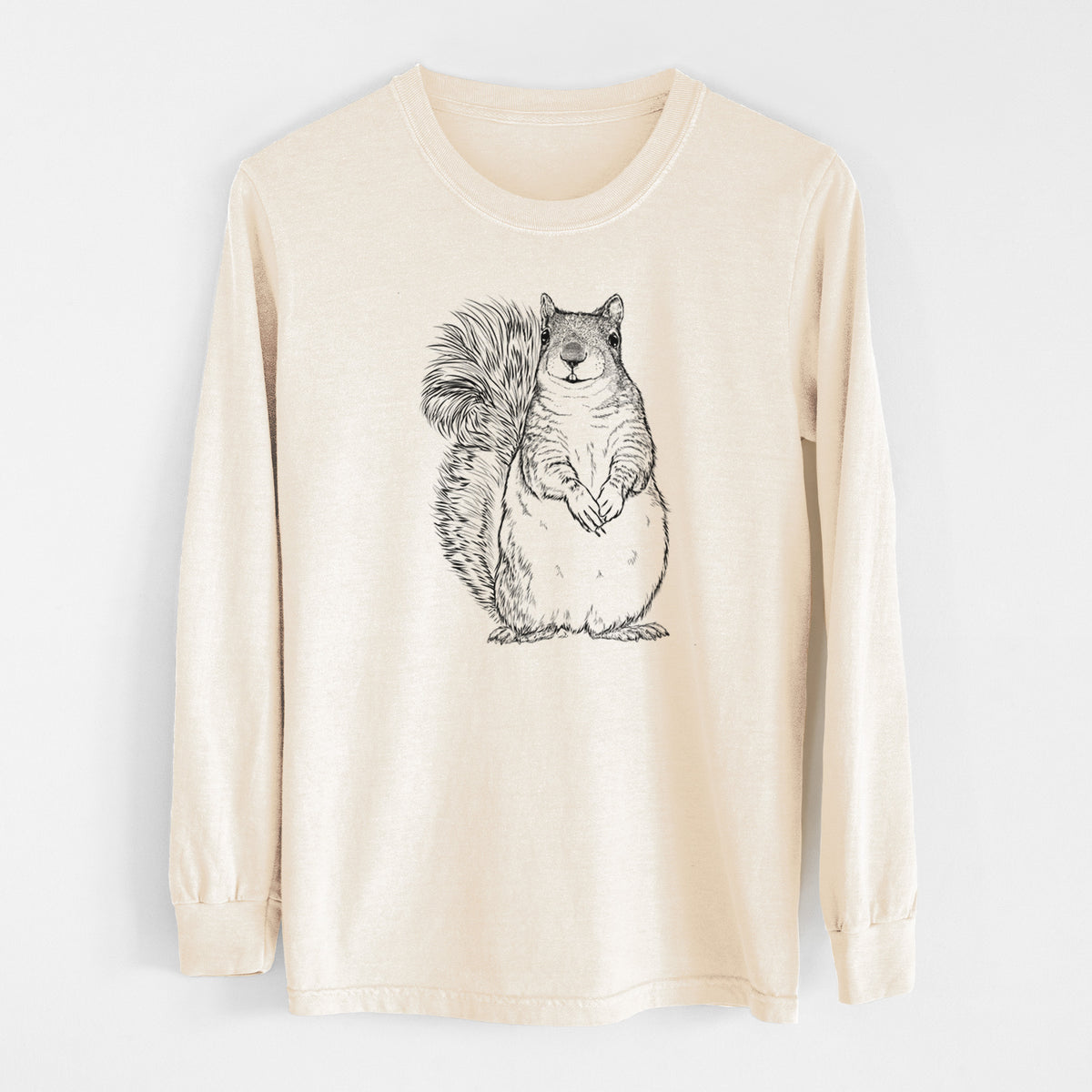 Ivory Comfort Colors long sleeve shirt laid flat, printed with a detailed black ink illustration of a western grey squirrel sitting upright with a bushy tail.