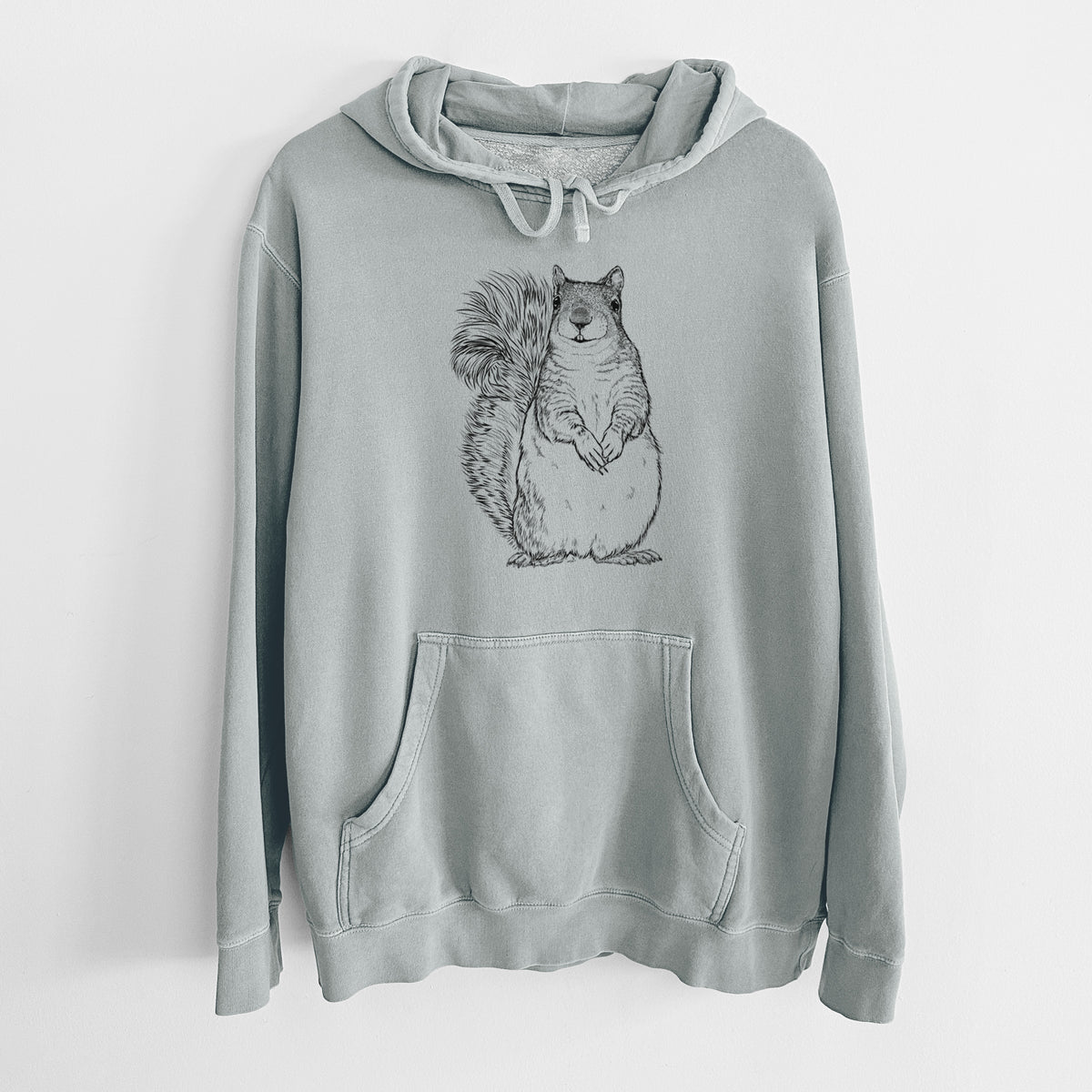 Sage green pigment dyed hoodie laid flat, printed with a detailed black ink illustration of a western grey squirrel sitting upright with a bushy tail.
