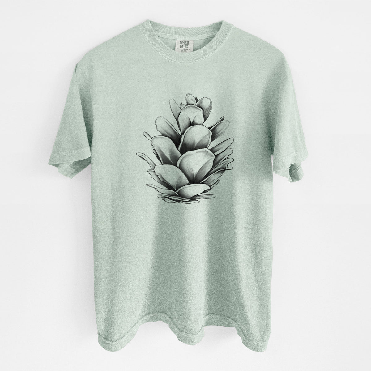 Bay green Comfort Colors t-shirt laid flat, printed with a detailed black ink illustration of a western hemlock pine cone.