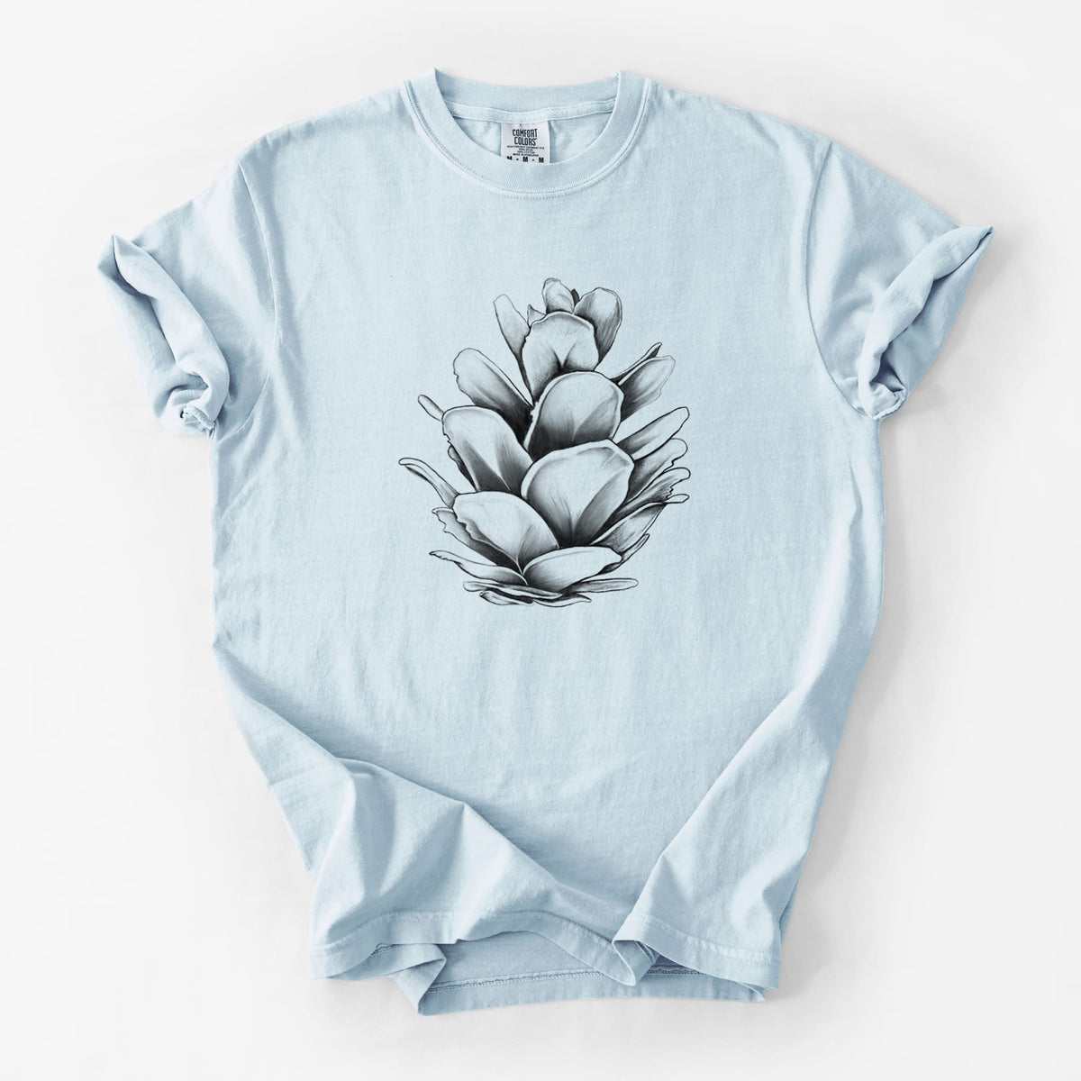 Chambray blue Comfort Colors t-shirt laid flat, printed with a detailed black ink illustration of a western hemlock pine cone.