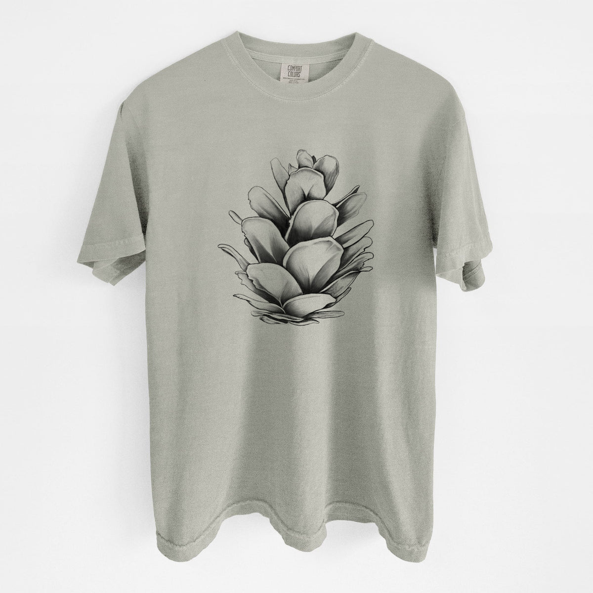 Sandstone beige Comfort Colors t-shirt laid flat, printed with a detailed black ink illustration of a western hemlock pine cone.