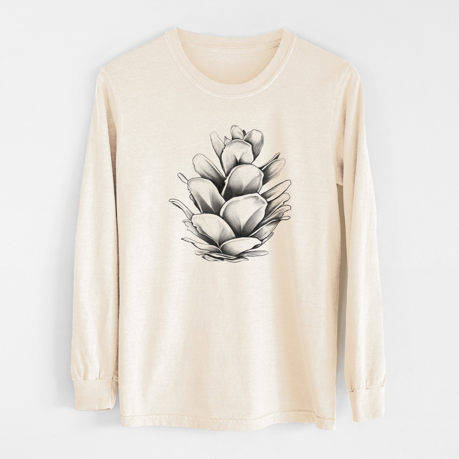 Ivory Comfort Colors long sleeve shirt laid flat, printed with a detailed black ink illustration of a western hemlock pine cone.