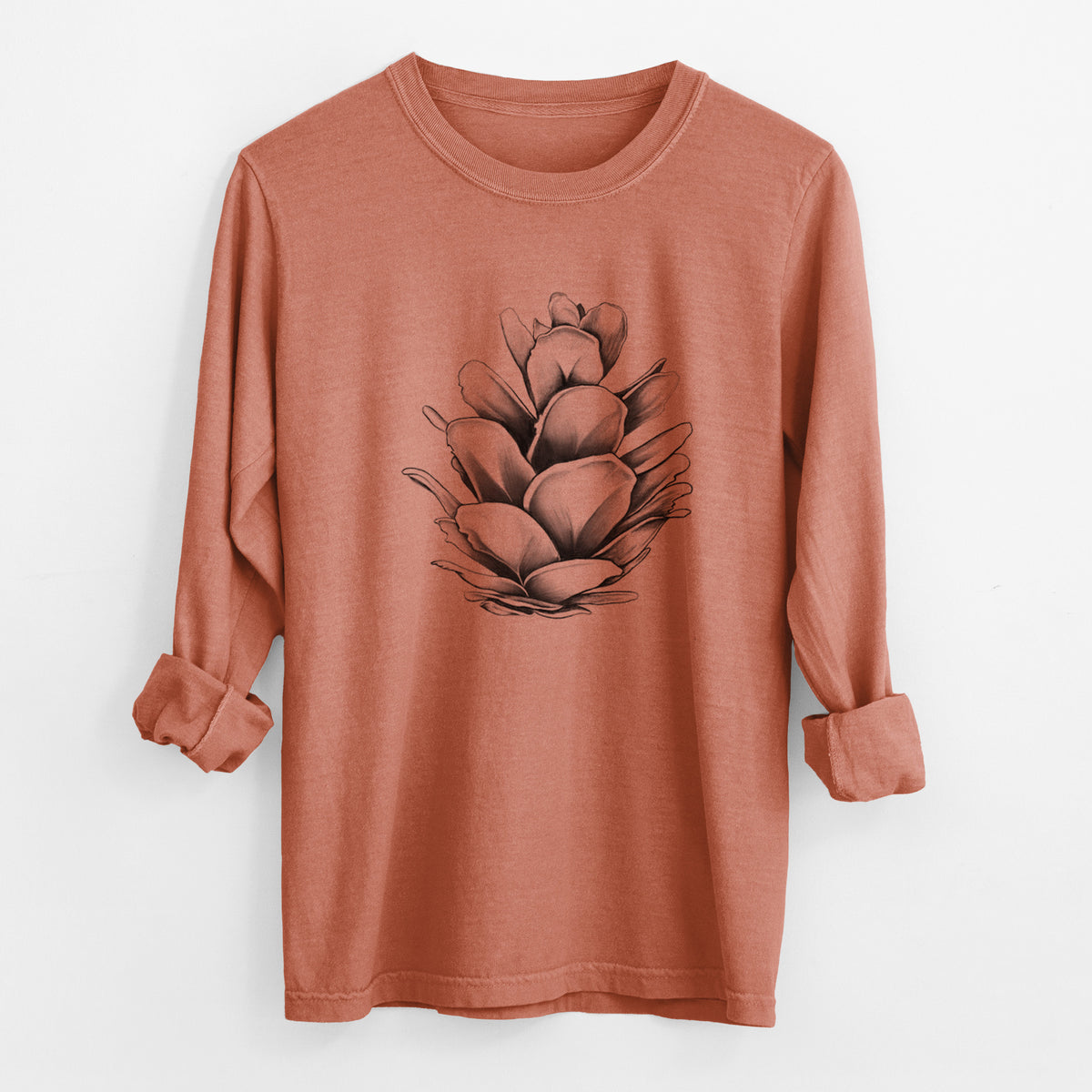 Yam burnt orange Comfort Colors long sleeve shirt laid flat with the cuffs rolled, printed with a detailed black ink illustration of a western hemlock pine cone.