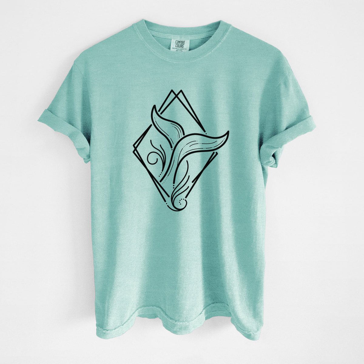 Chalky mint Comfort Colors t-shirt laid flat, printed with a black line art whale tail rising from a wave inside a diamond outline.