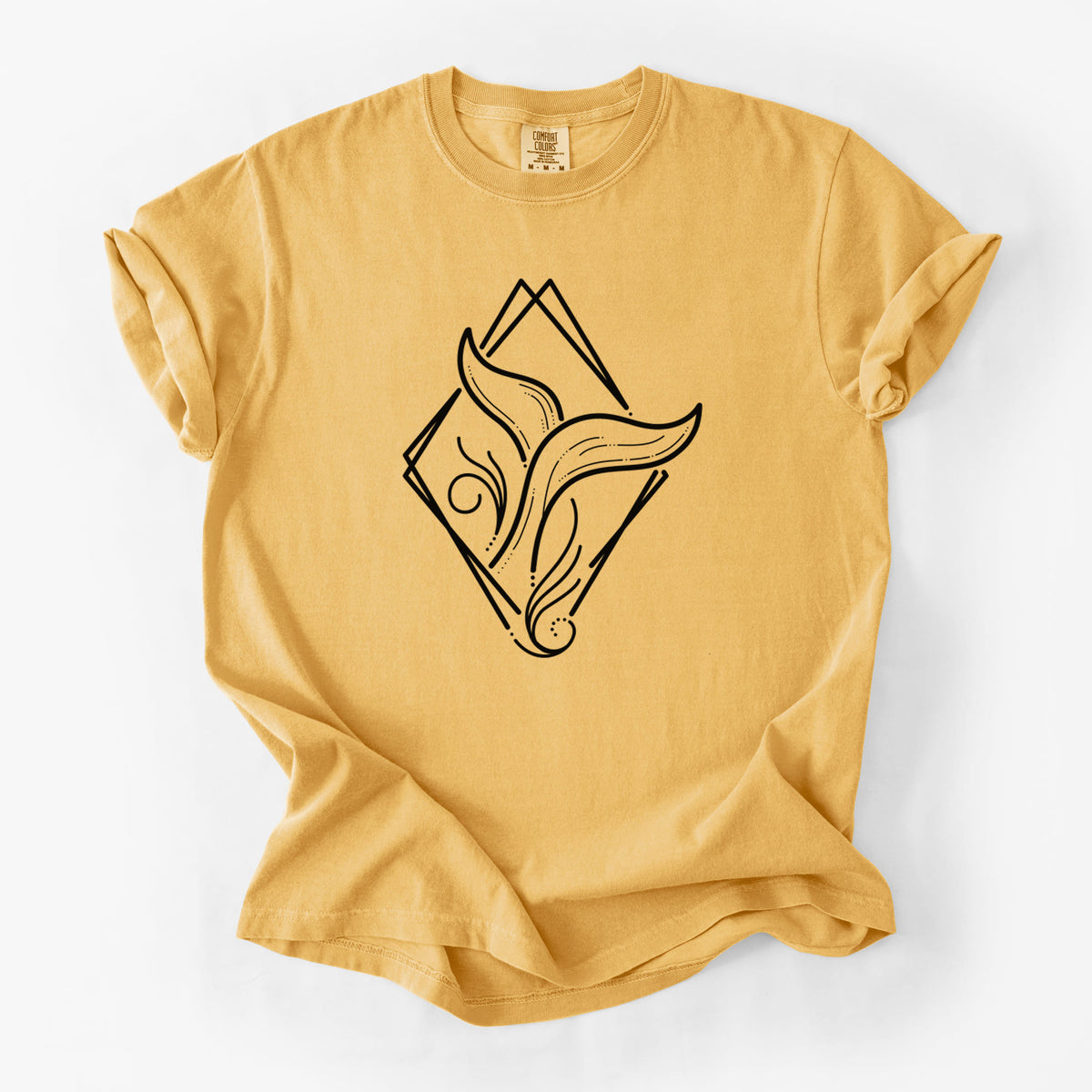 Golden wheat yellow Comfort Colors t-shirt laid flat, printed with a black line art whale tail rising from a wave inside a diamond outline.