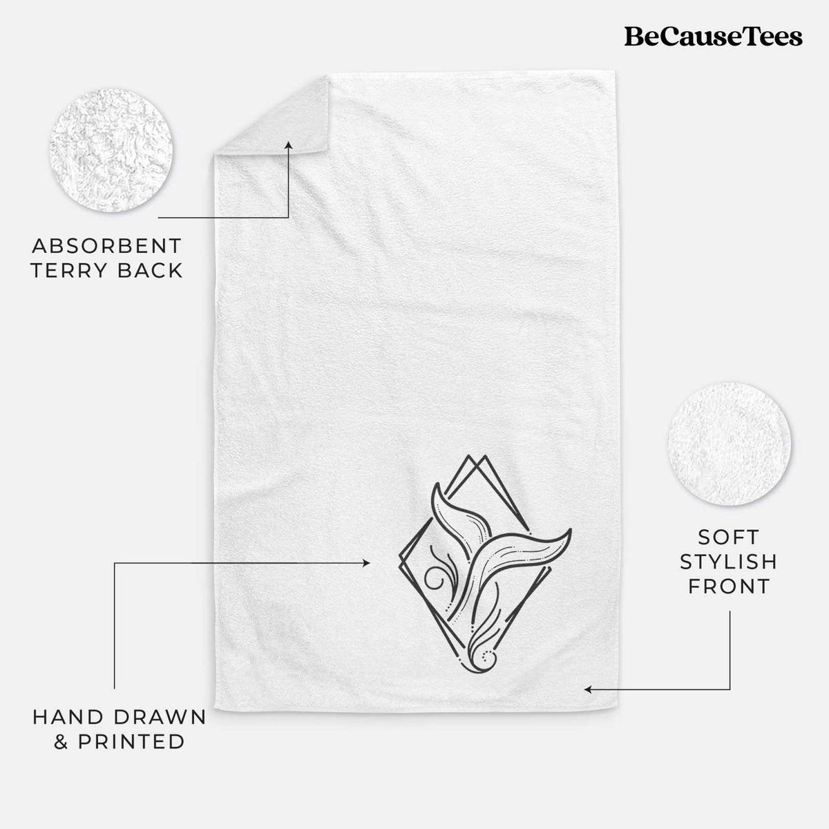 White hand towel printed with a black line art whale tail rising from a wave inside a diamond outline.