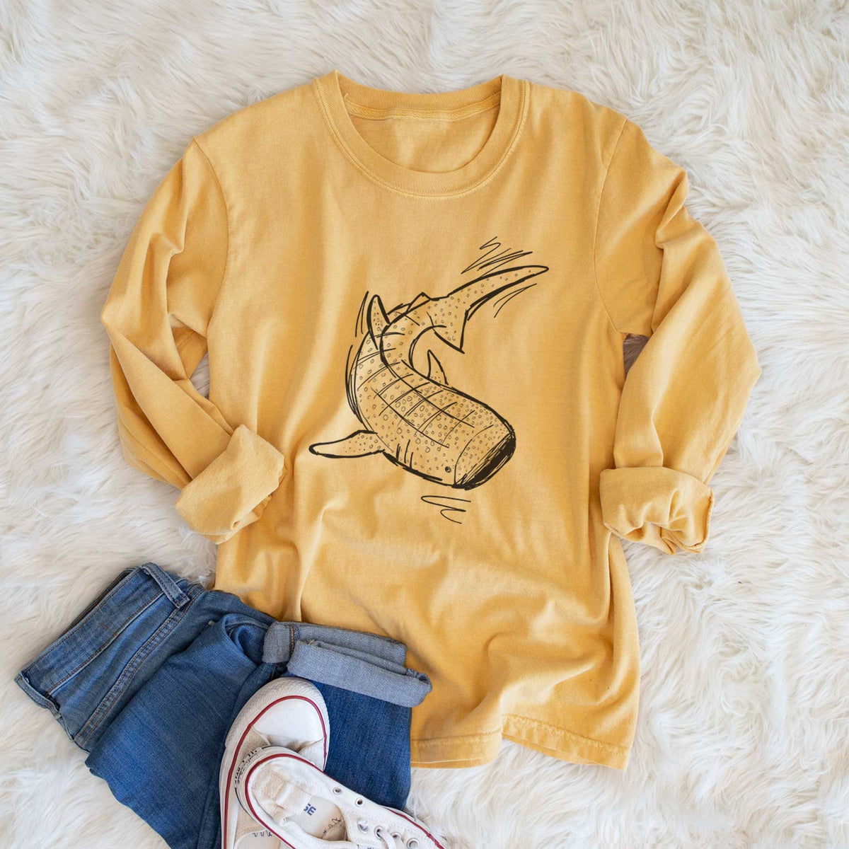 Golden wheat yellow Comfort Colors long sleeve shirt printed with a black ink illustration of a spotted whale shark swimming, shown in a lifestyle photo.