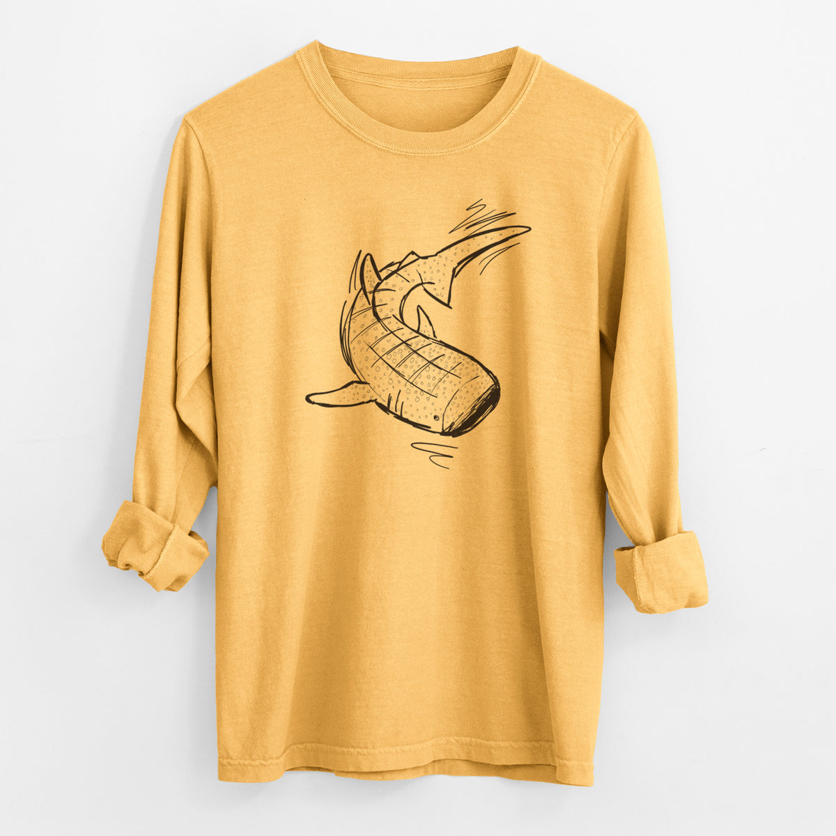 Golden wheat yellow Comfort Colors long sleeve shirt laid flat with the cuffs rolled, printed with a black ink illustration of a spotted whale shark swimming.