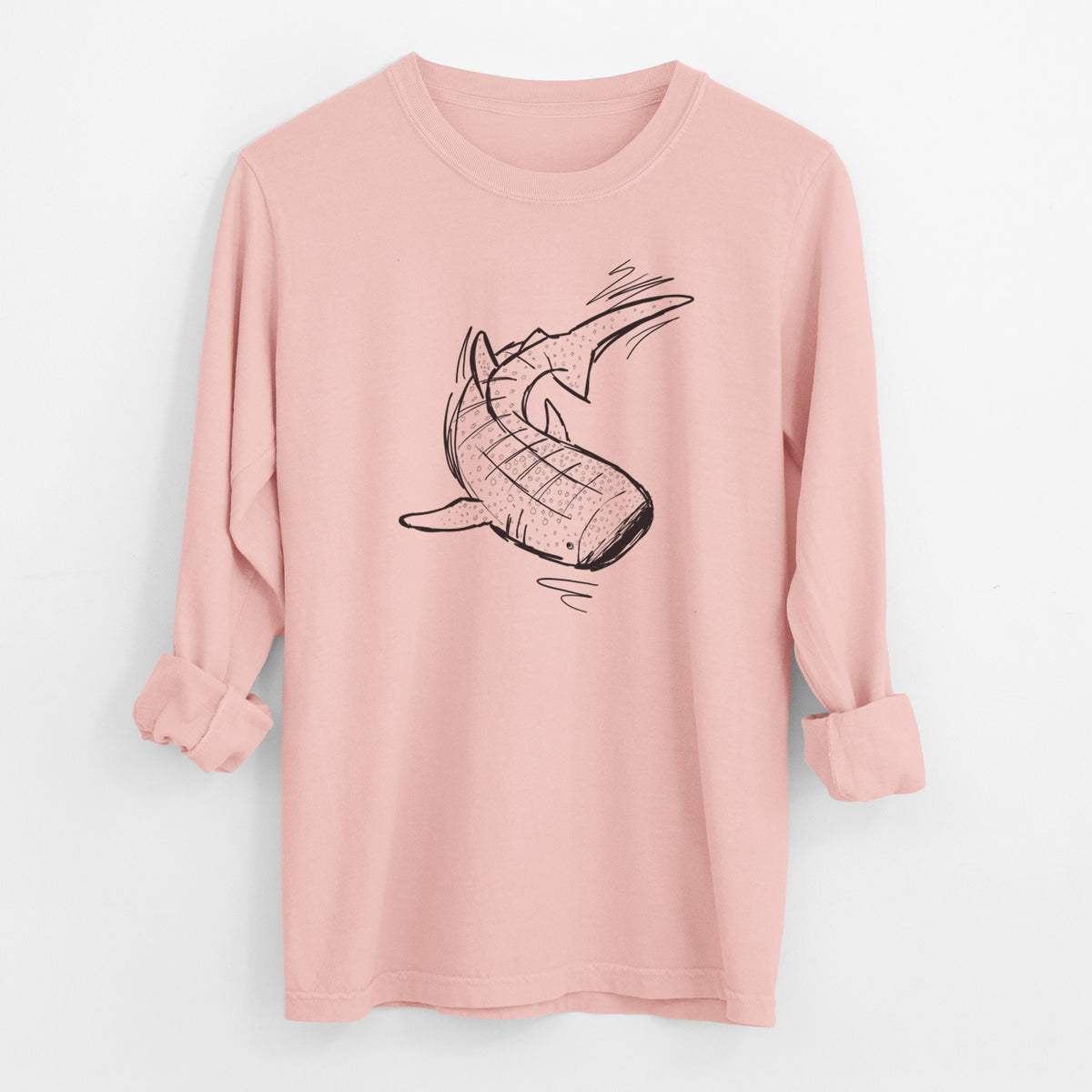Peachy Comfort Colors long sleeve shirt laid flat with the cuffs rolled, printed with a black ink illustration of a spotted whale shark swimming.