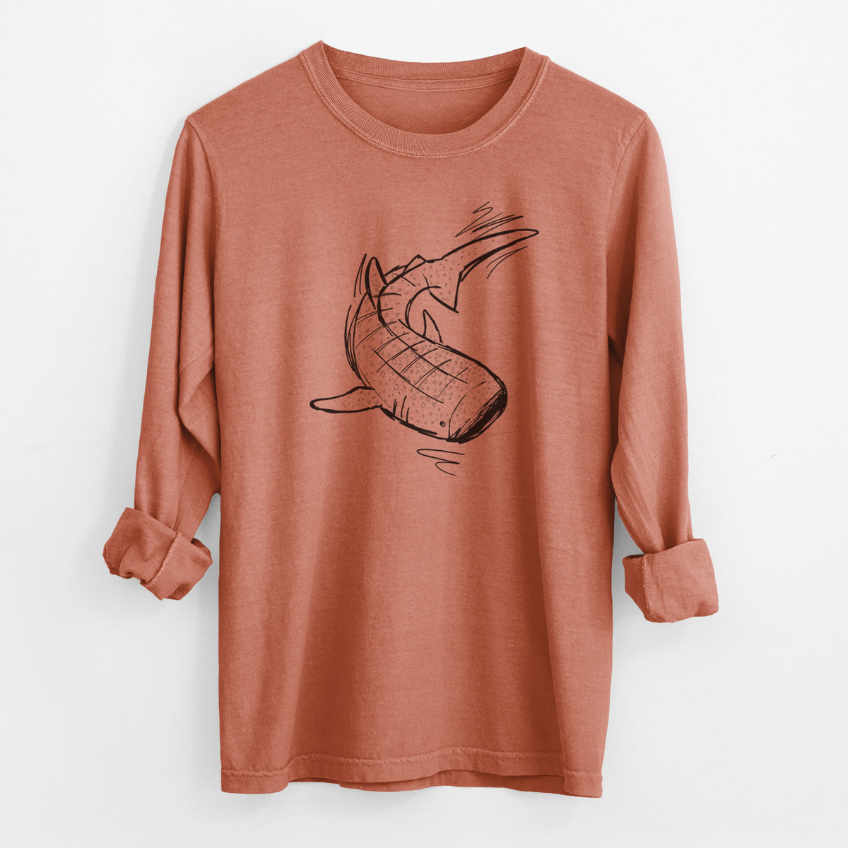Yam burnt orange Comfort Colors long sleeve shirt laid flat with the cuffs rolled, printed with a black ink illustration of a spotted whale shark swimming.