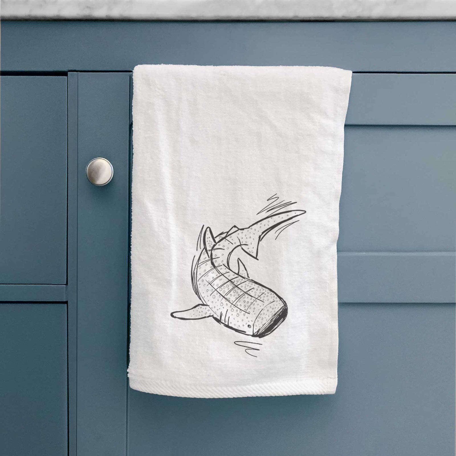 White hand towel printed with a black ink illustration of a spotted whale shark swimming.