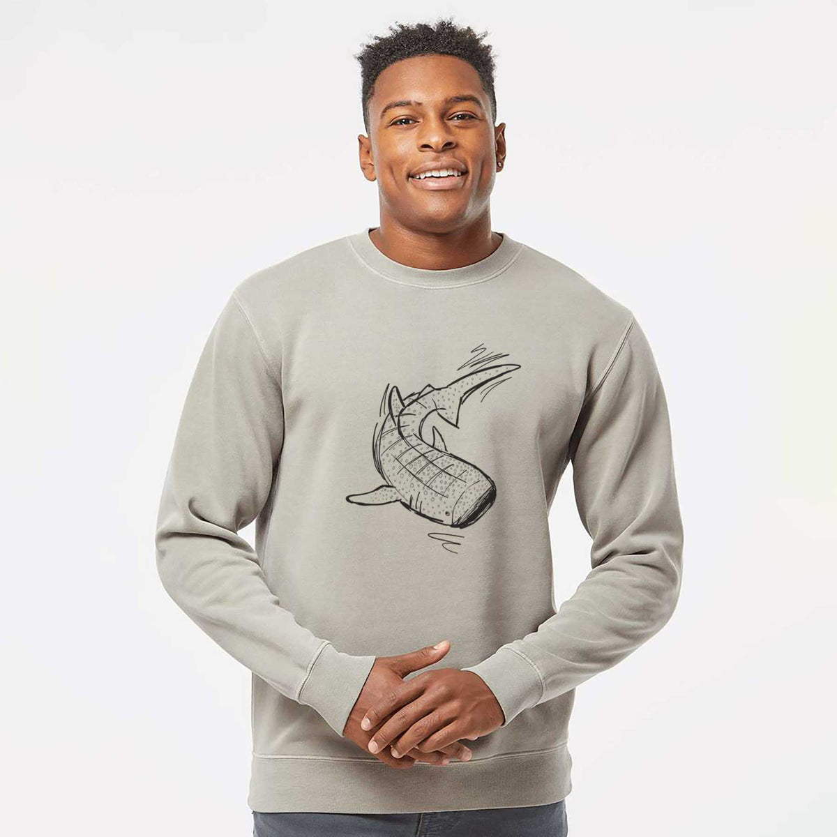 Model wearing a cement grey pigment dyed crewneck sweatshirt printed with a black ink illustration of a spotted whale shark swimming.