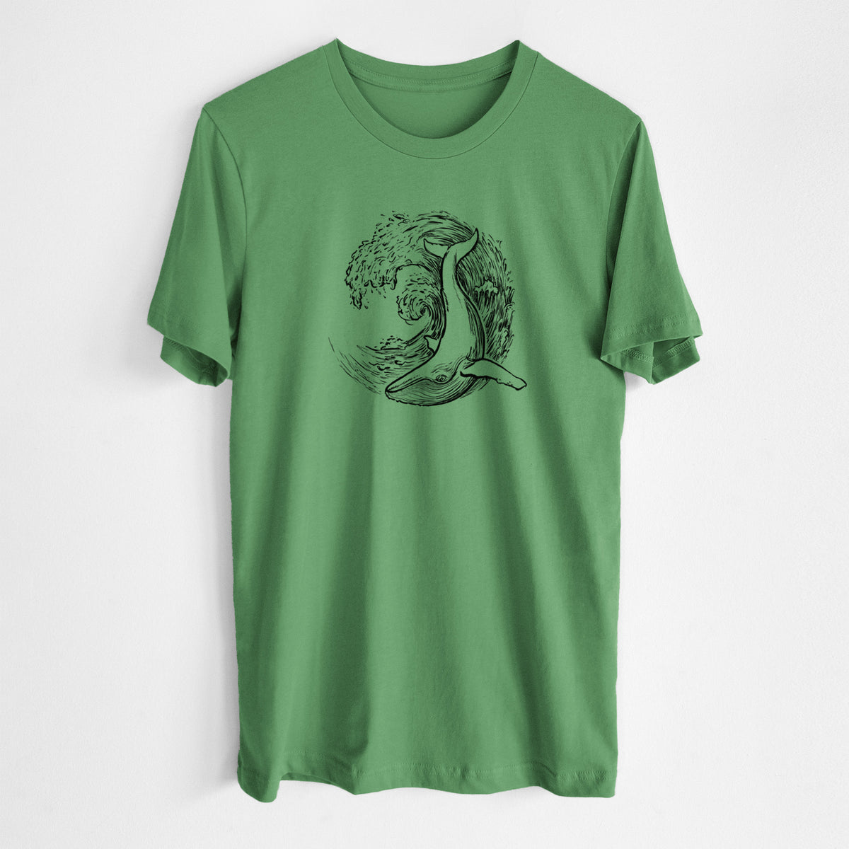 Leaf green lightweight cotton t-shirt laid flat, printed with a black ink illustration of a humpback whale swimming inside a curling ocean wave.