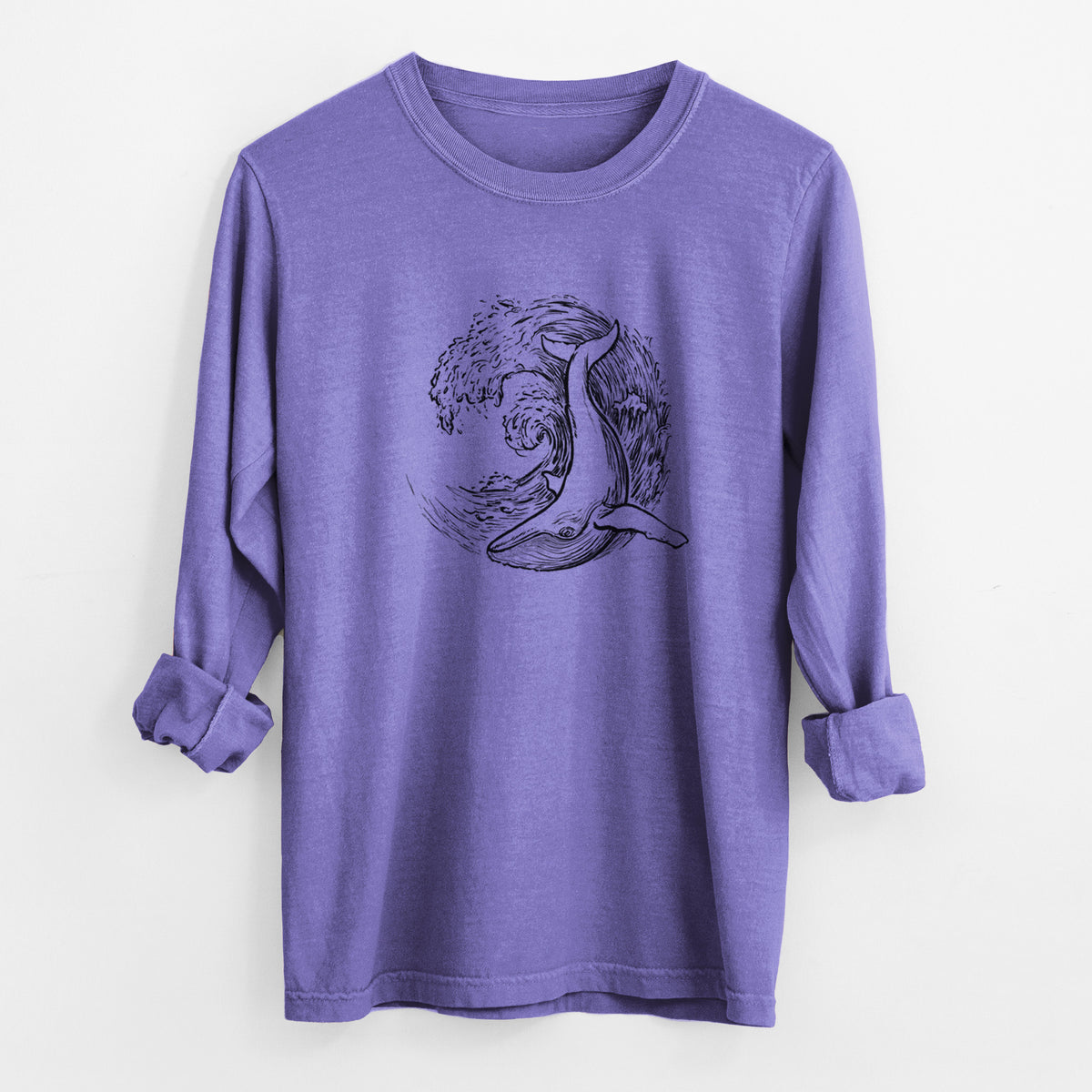 Violet purple Comfort Colors long sleeve shirt laid flat with the cuffs rolled, printed with a black ink illustration of a humpback whale swimming inside a curling ocean wave.