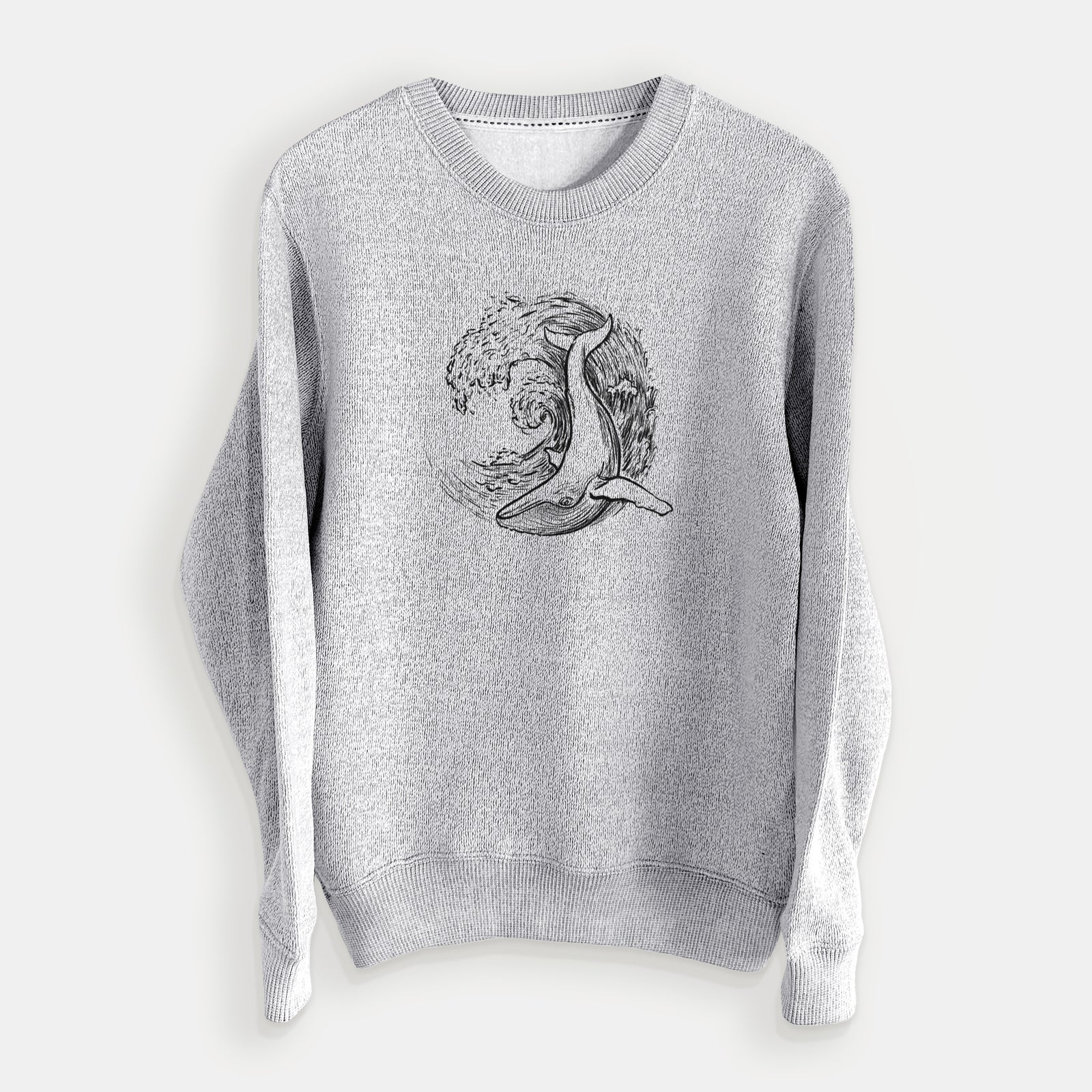 Salt and pepper knit sweatshirt laid flat, printed with a black ink illustration of a humpback whale swimming inside a curling ocean wave.