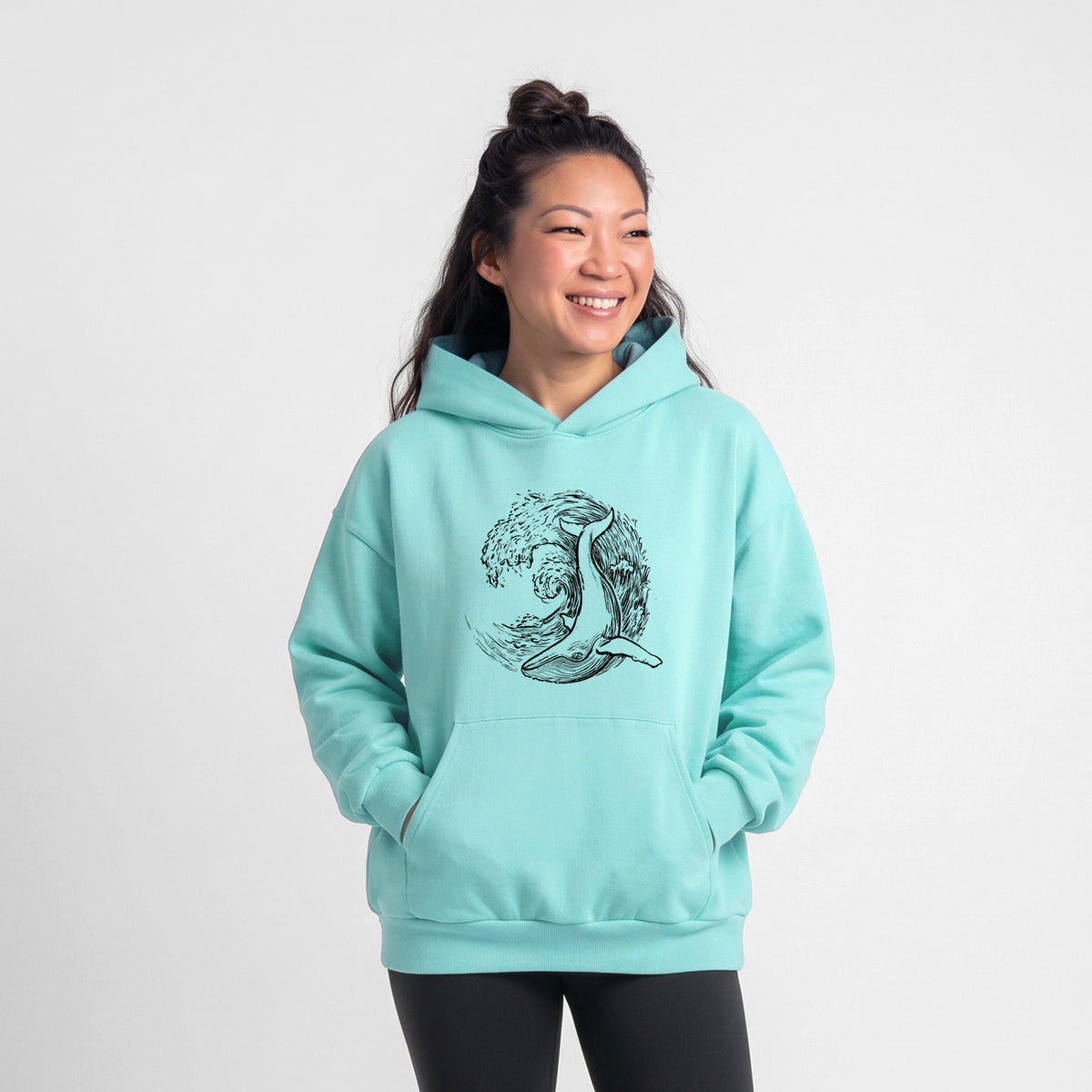 Female model wearing the Whale Wave - Statement Midweight Hoodie.