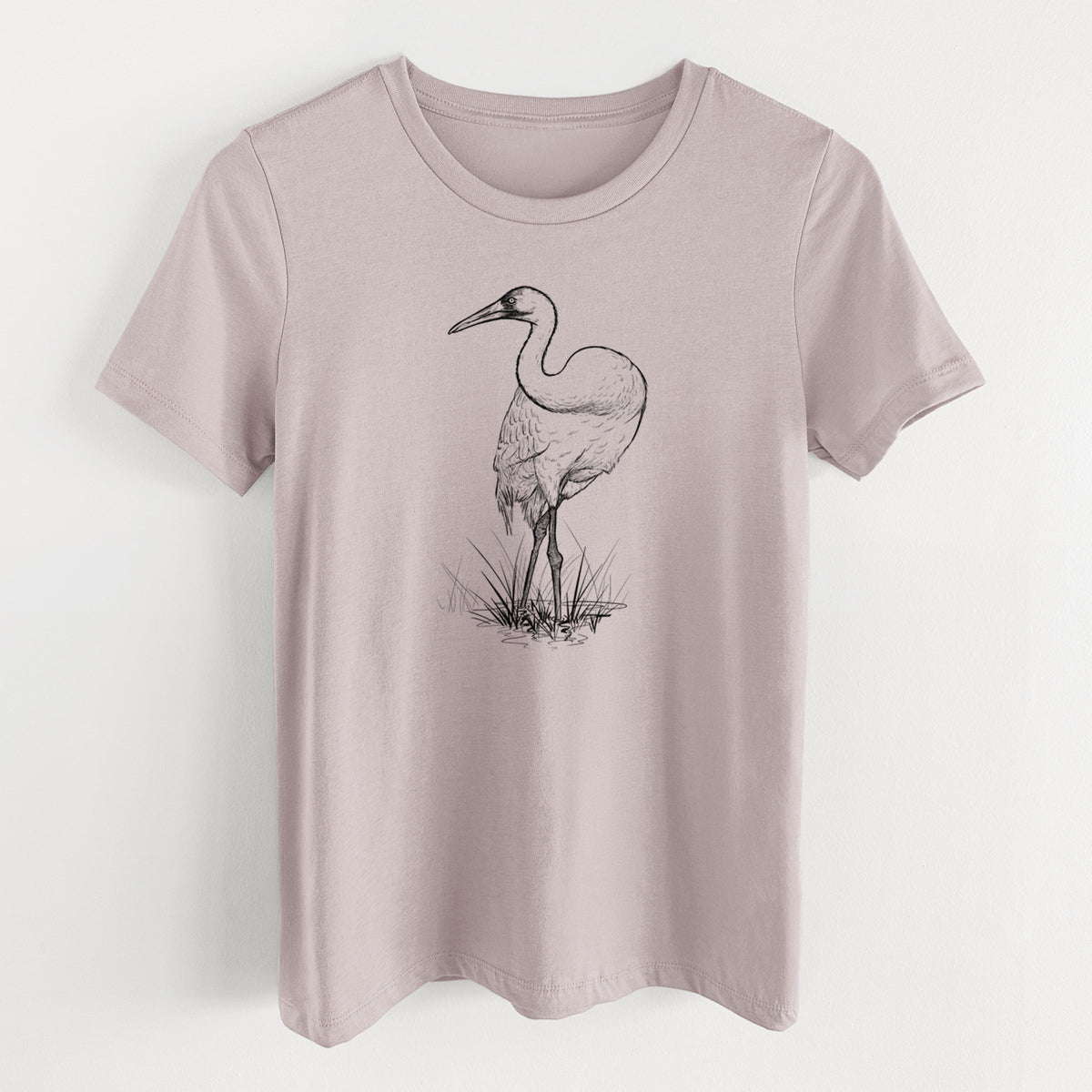 Pink gravel women's relaxed fit cotton t-shirt laid flat, printed with a detailed black ink illustration of a whooping crane standing in grass.