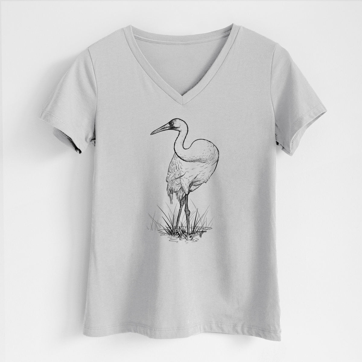 Lunar grey women's relaxed fit cotton V-neck t-shirt laid flat, printed with a detailed black ink illustration of a whooping crane standing in grass.