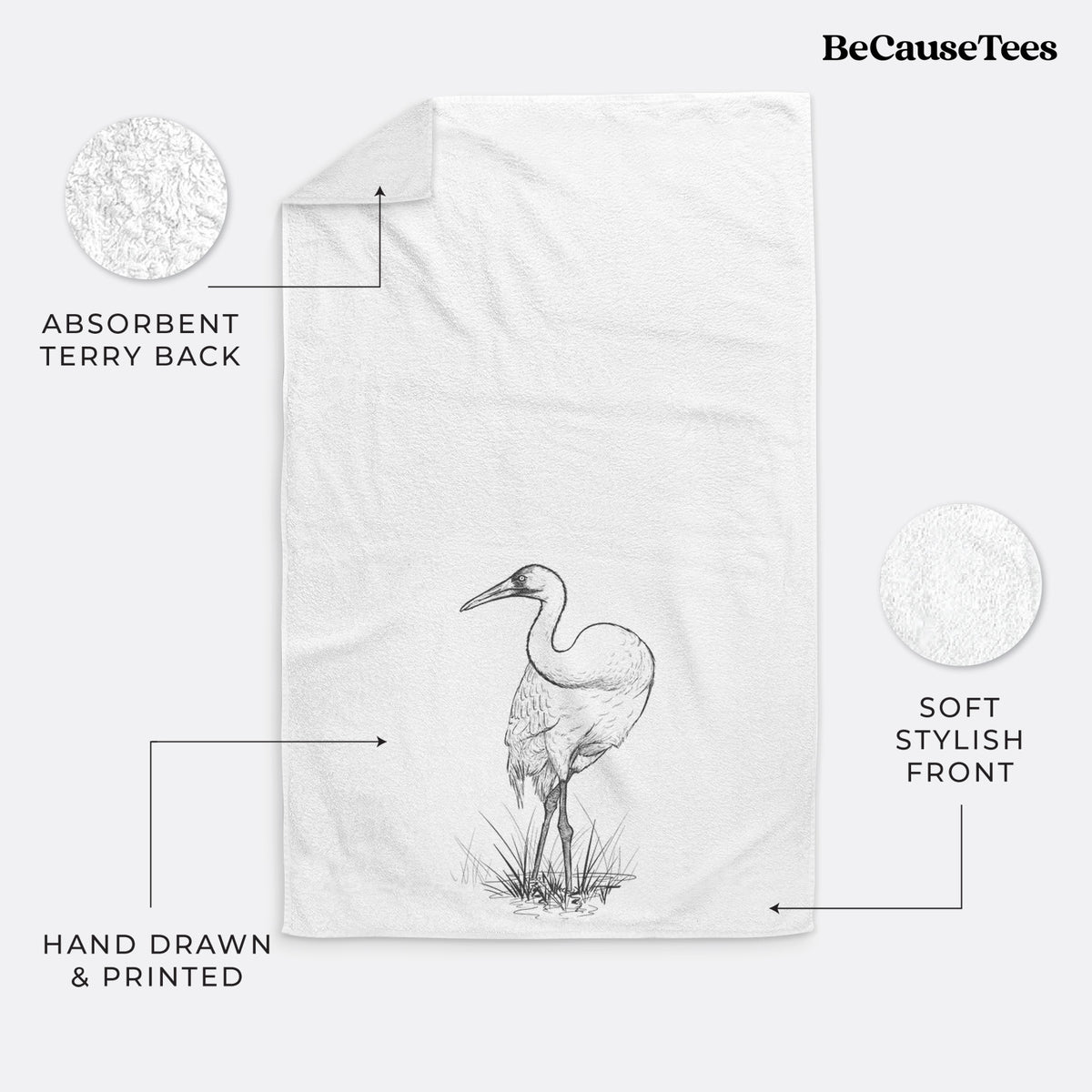 White hand towel printed with a detailed black ink illustration of a whooping crane standing in grass.