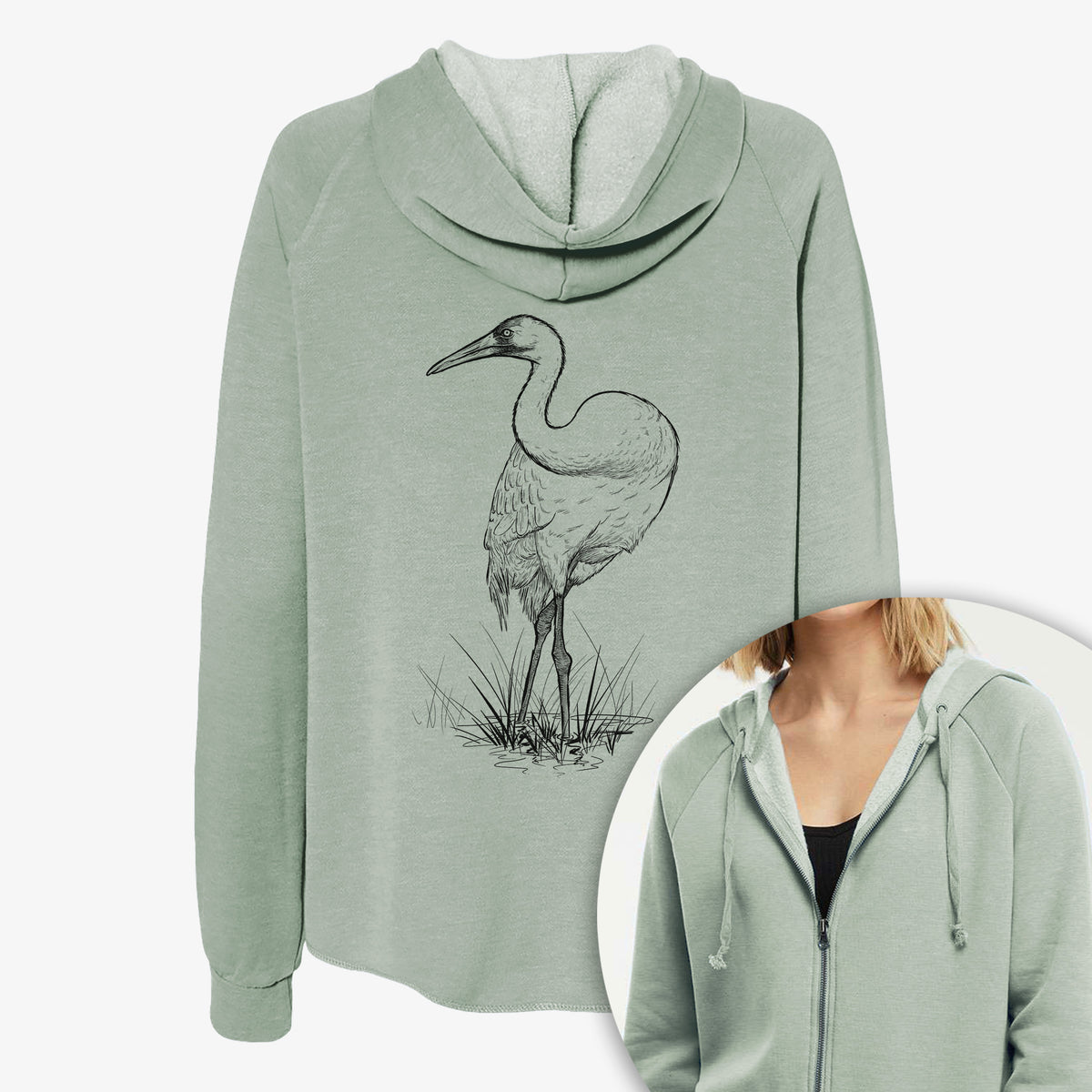 Women's Cali Wave zip-up sweatshirt printed with a detailed black ink illustration of a whooping crane standing in grass, with a close-up of the zipper.