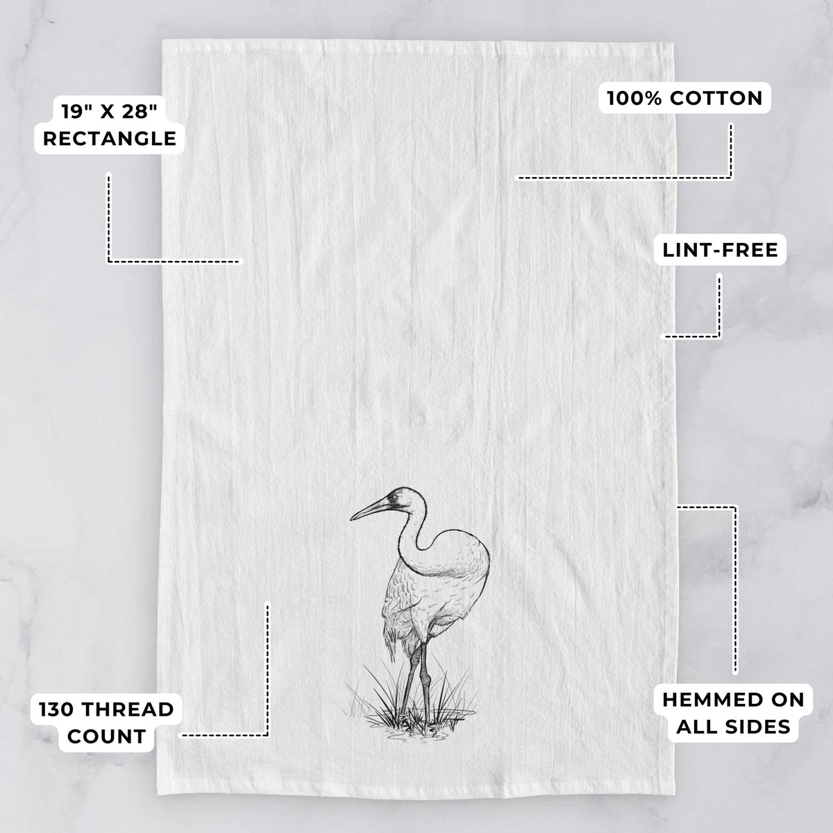 White tea towel printed with a detailed black ink illustration of a whooping crane standing in grass, with feature labels: 19 by 28 inch rectangle, 100% cotton, lint-free, 130 thread count, hemmed on all sides.
