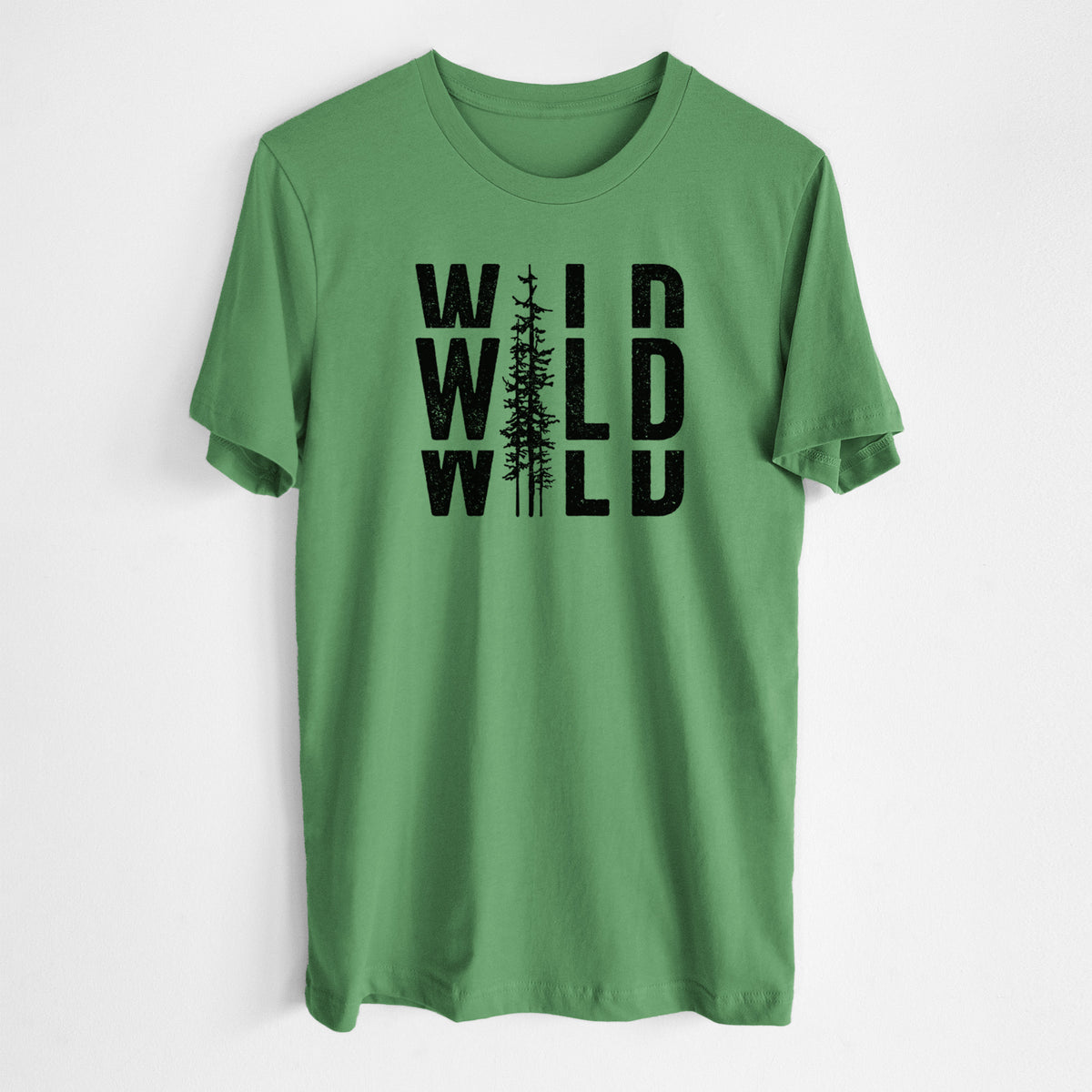 Leaf green lightweight cotton t-shirt laid flat, printed with bold black text reading WILD stacked three times, with a tall pine tree forming the letter I.