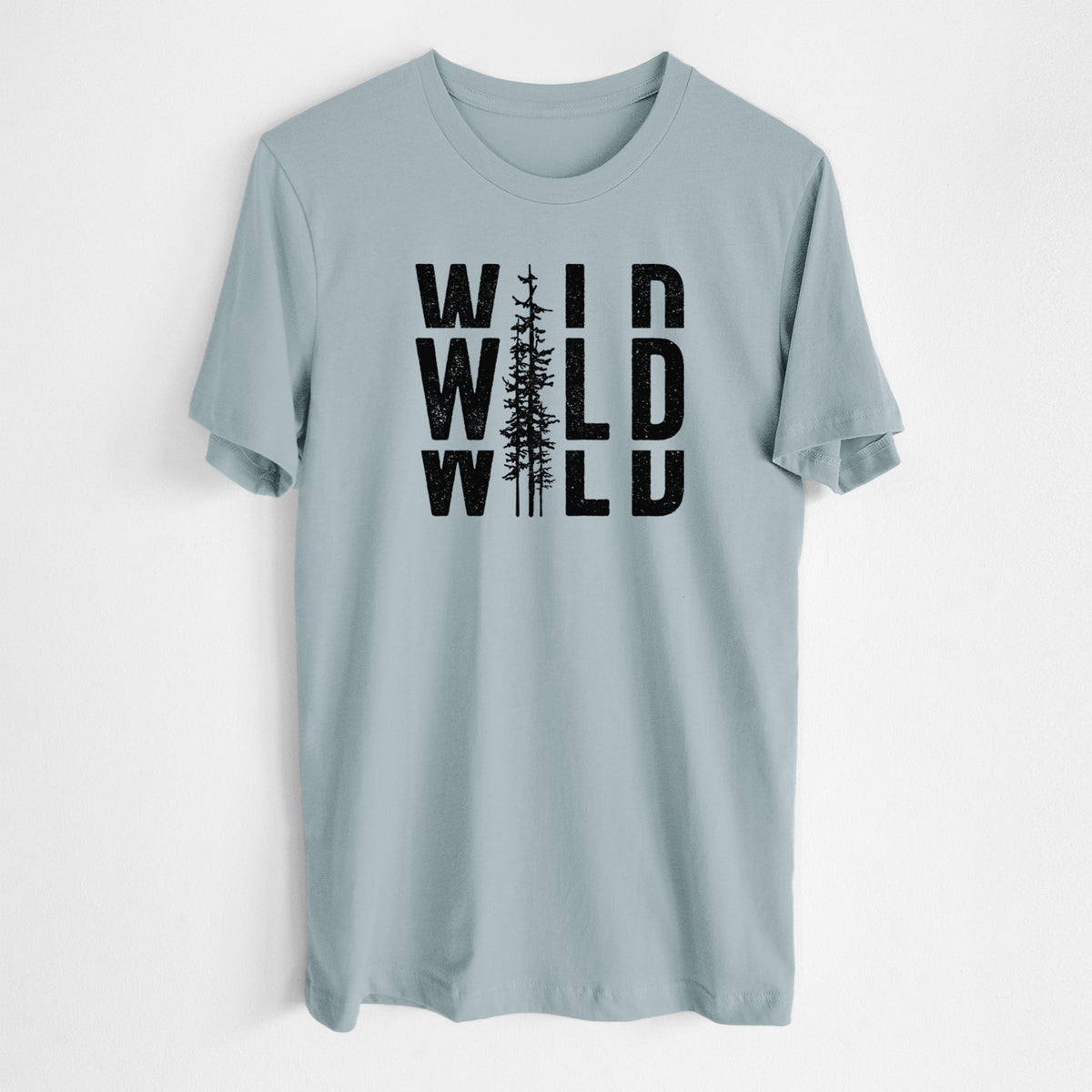 Vintage denim lightweight cotton t-shirt laid flat, printed with bold black text reading WILD stacked three times, with a tall pine tree forming the letter I.