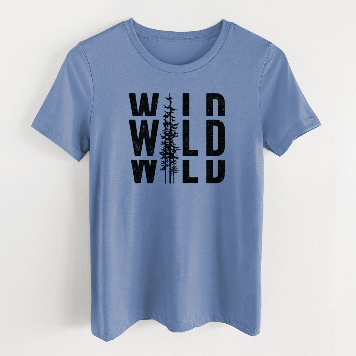 Blue bell women's relaxed fit cotton t-shirt laid flat, printed with bold black text reading WILD stacked three times, with a tall pine tree forming the letter I.